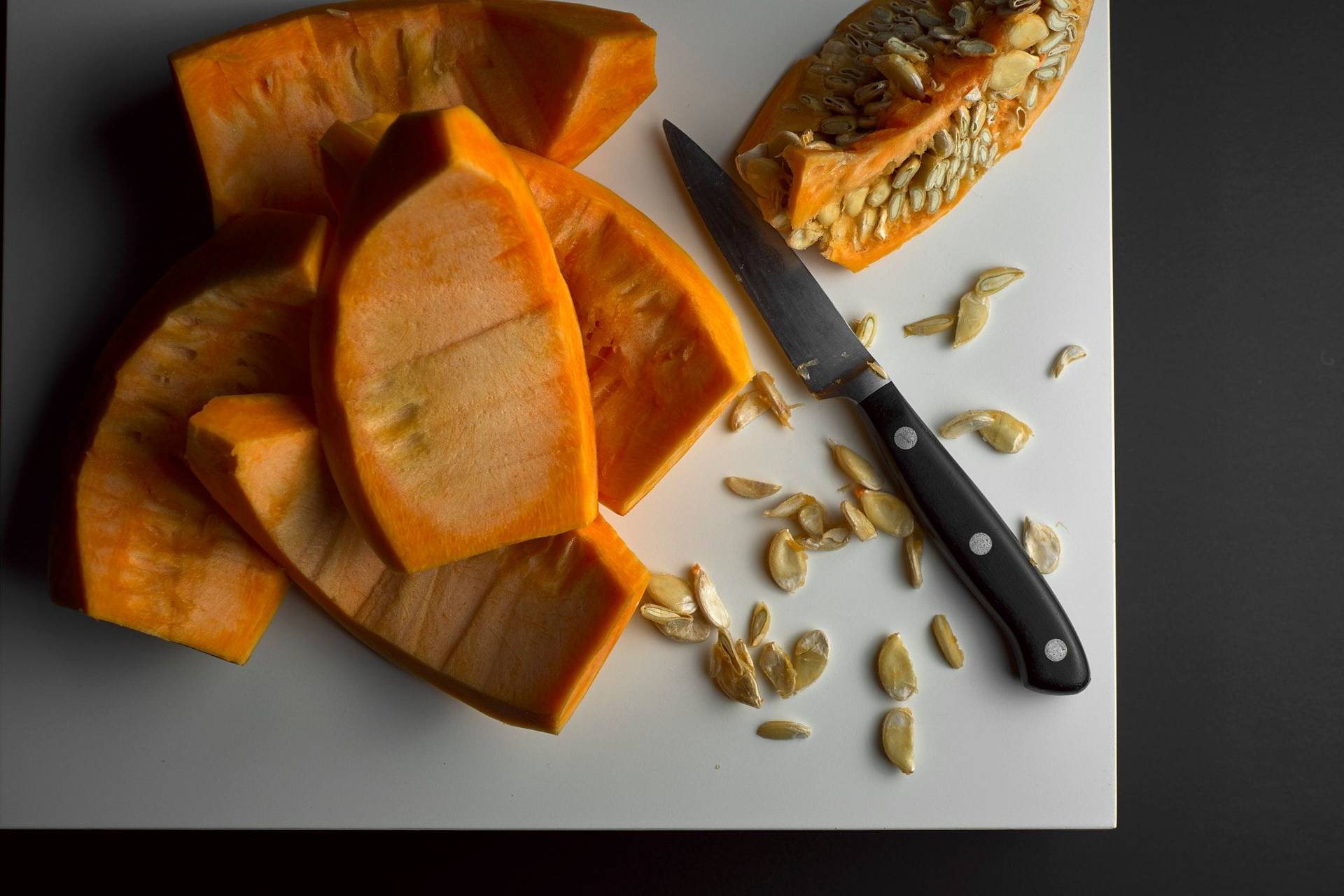 cut pumpkin on a white board