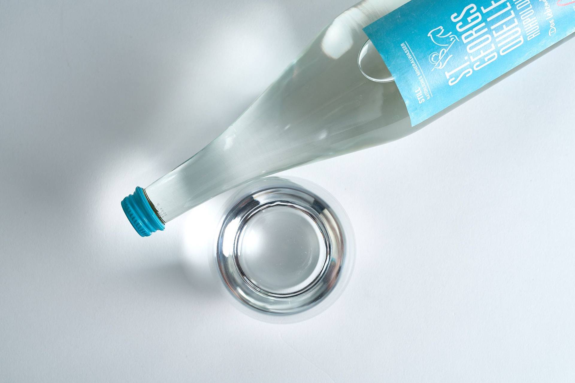 mineral water bottle and glass on white background