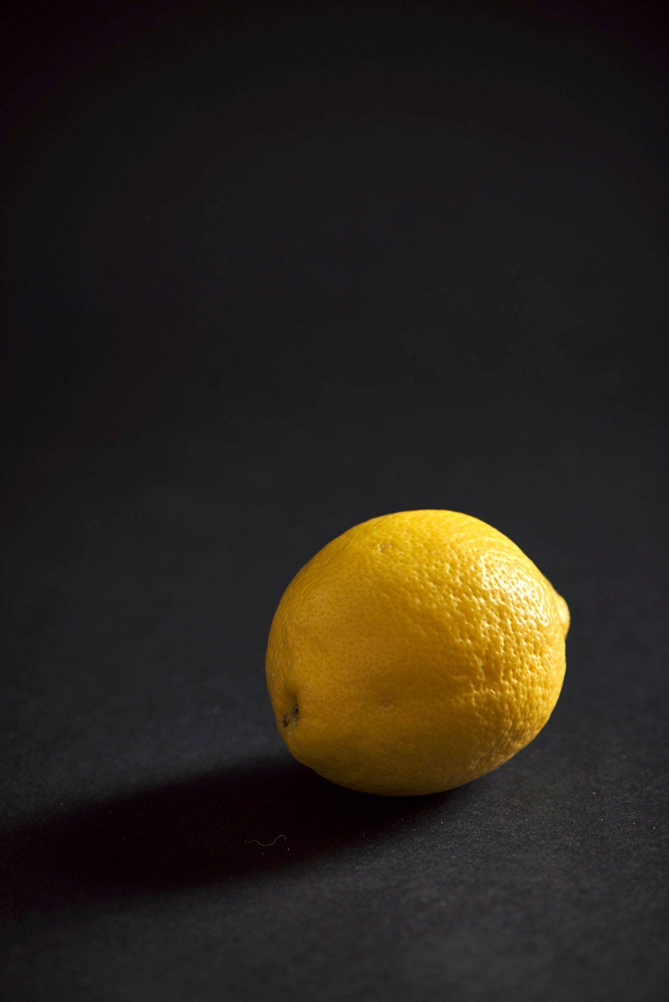 a lemon on black background