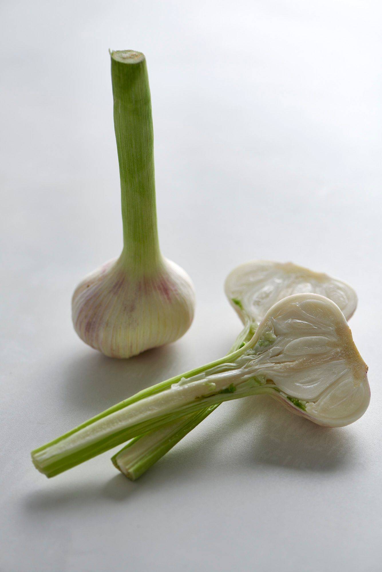 two pieces of garlic on a white sapienstone top