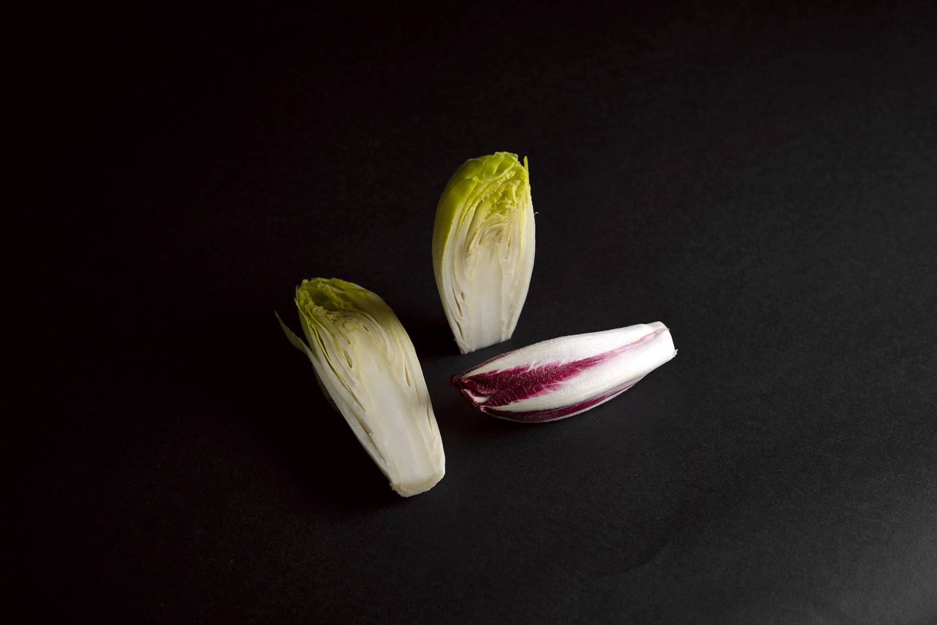 three pieces of yellow and red chicory with black background