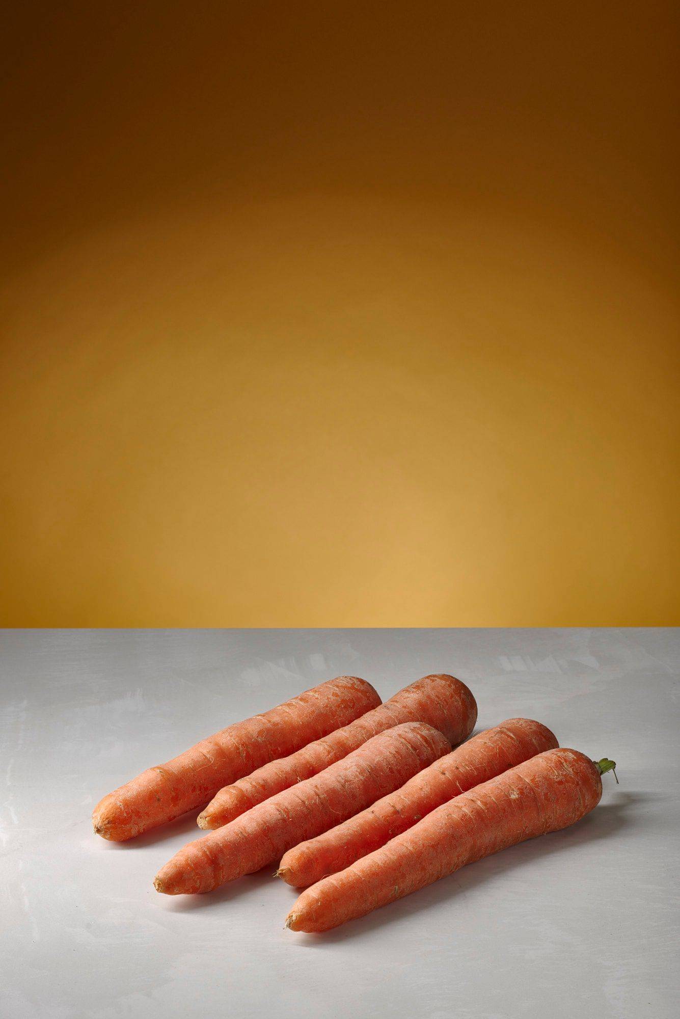 five carrots with white sapienstone top and yellow background