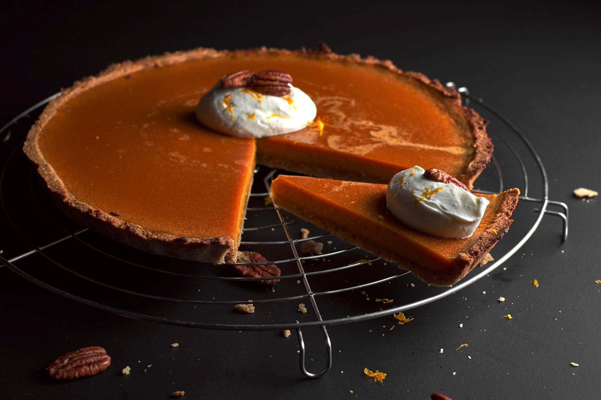 creamy pumpkin pie on black background