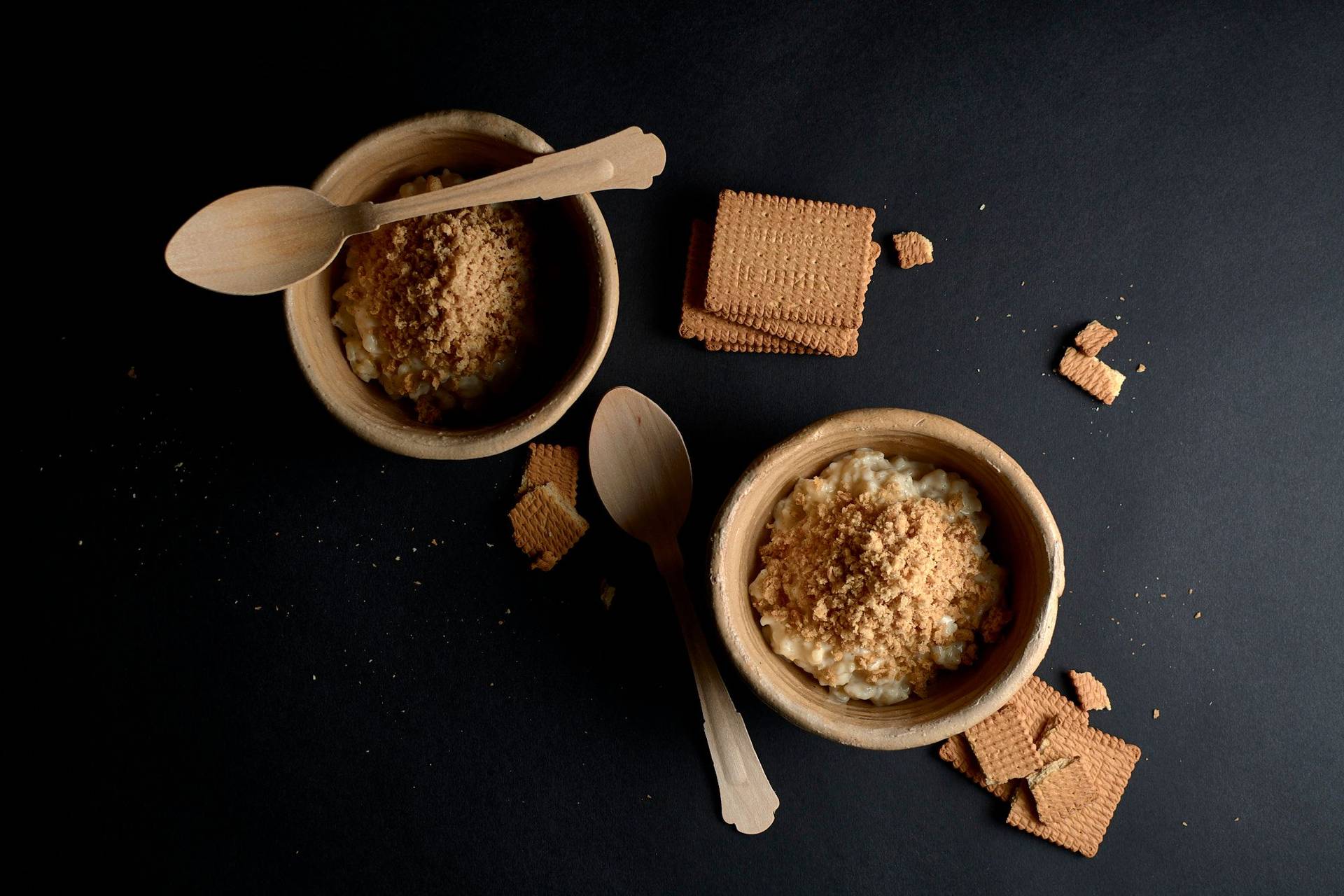 rice pudding with shortbread snow on black background