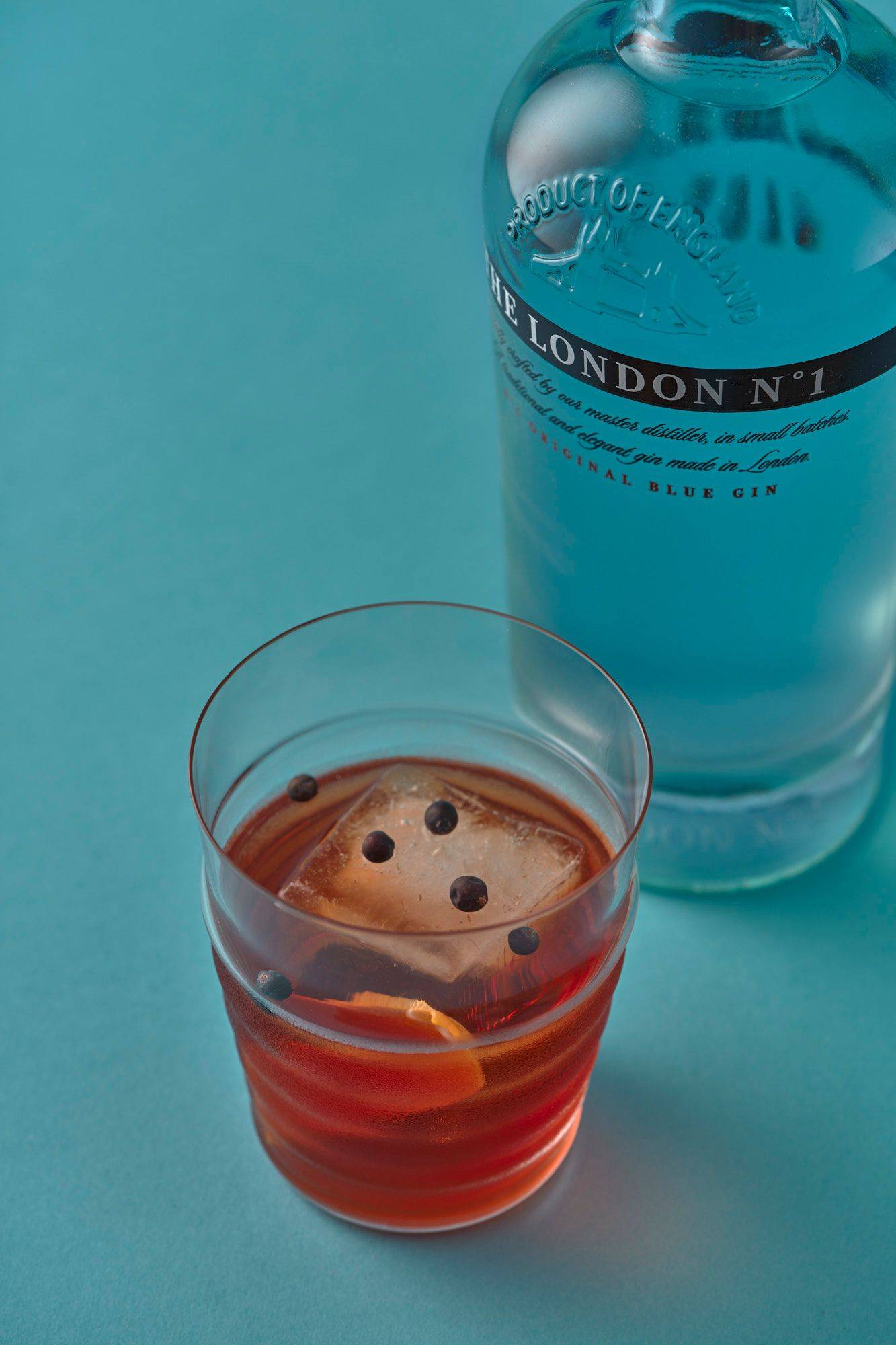negroni aperitif with the london number one gin on blue background