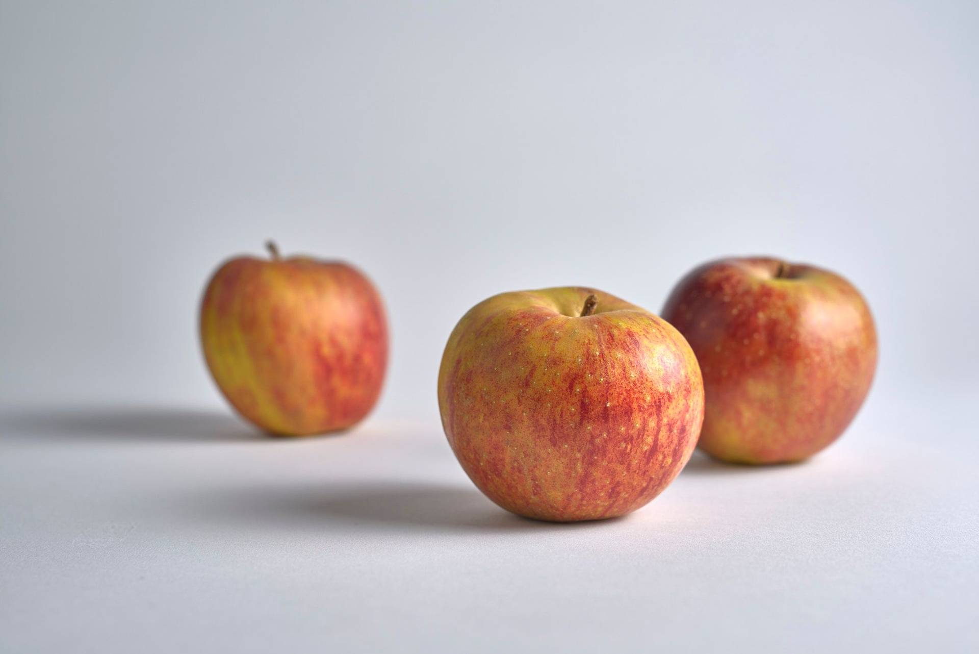 three red apples with white background