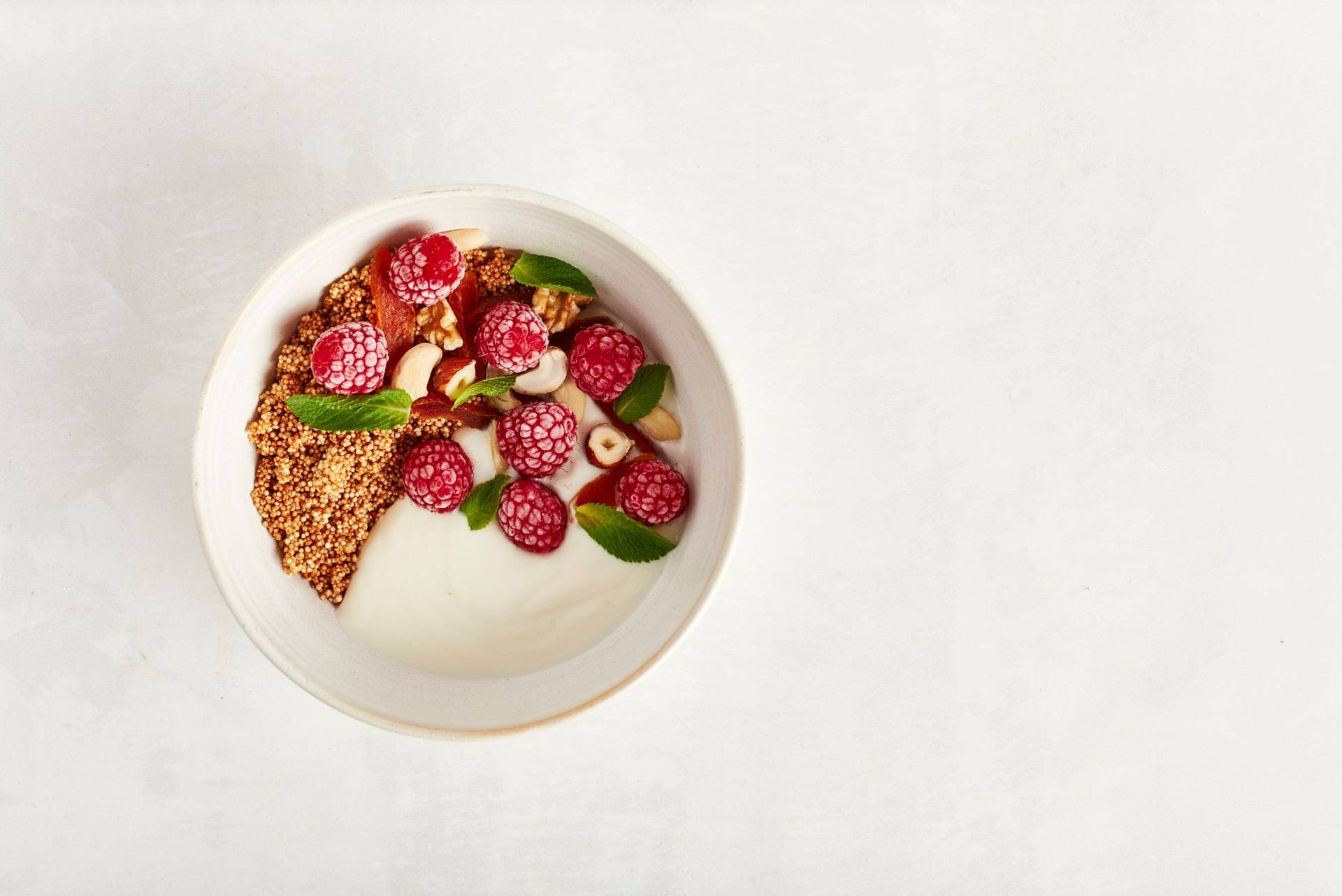 amaranth breakfast bowl with berries on white background