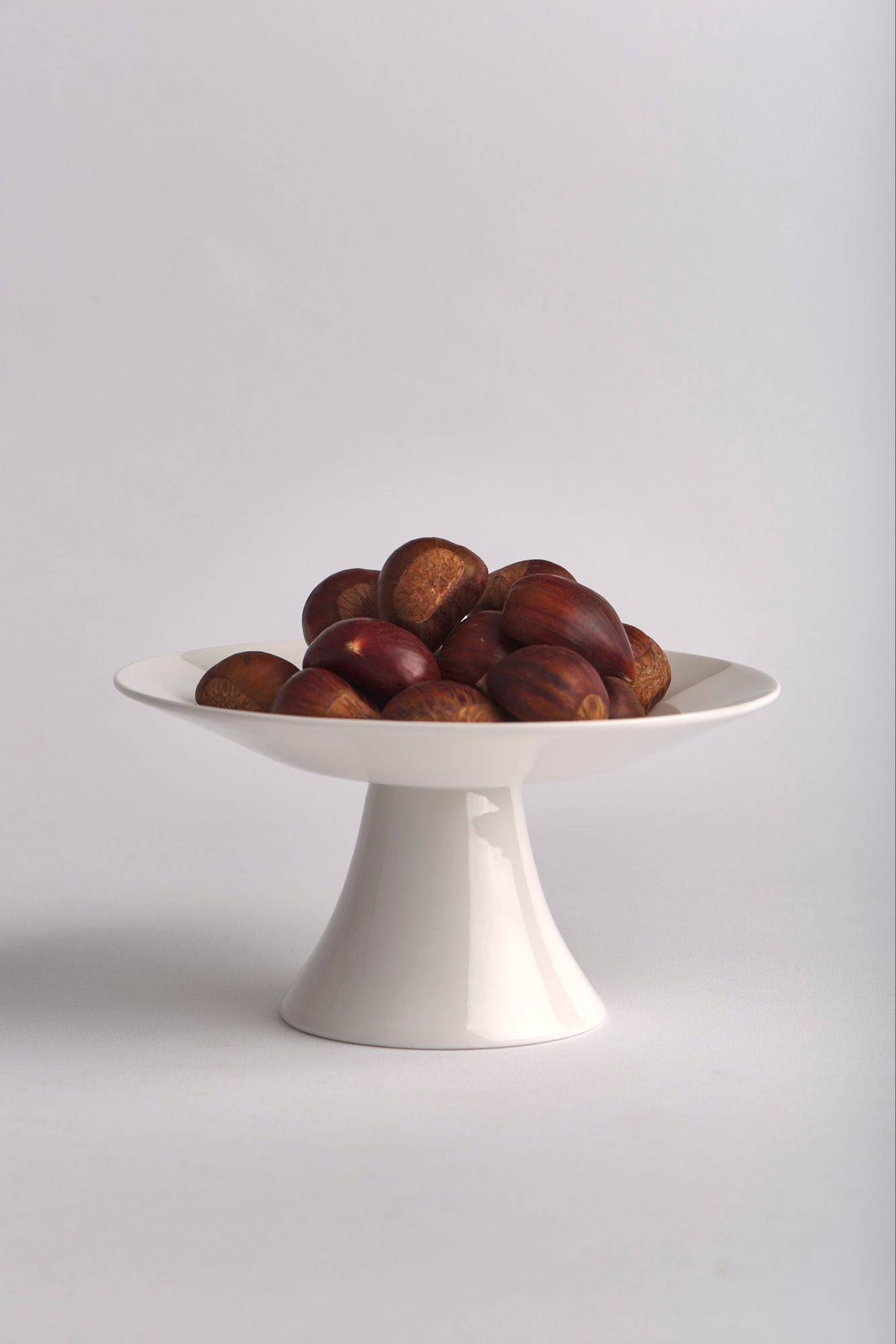 chestnuts on a small stand on white background