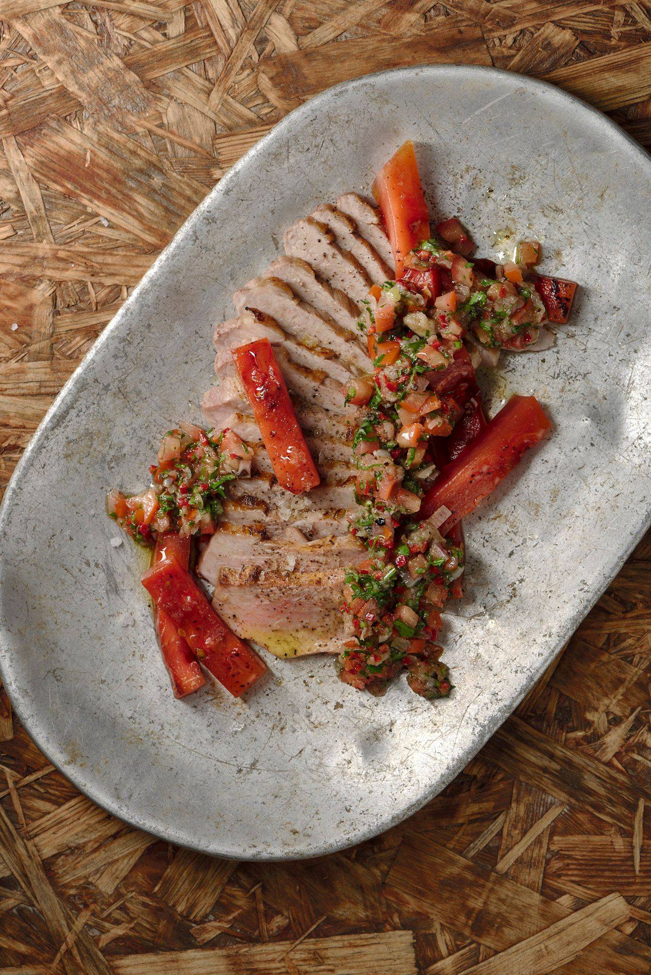 pork-secreto-with-grilled-watermelon-and-chimichurri pork secreto with grilled watermelon and chimichurri on a vintage aluminum plate with wooden background