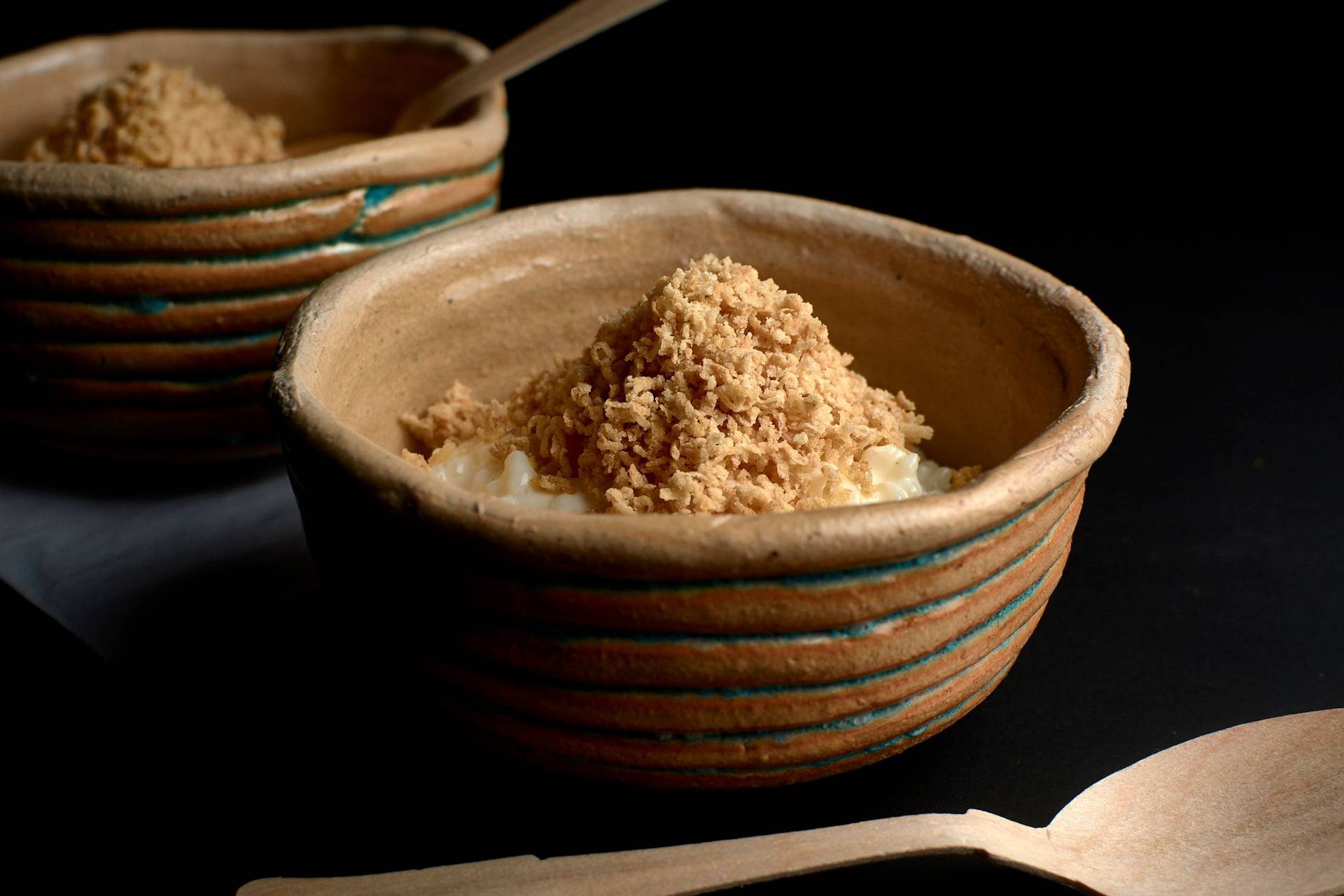 rice pudding with shortbread snow on black background