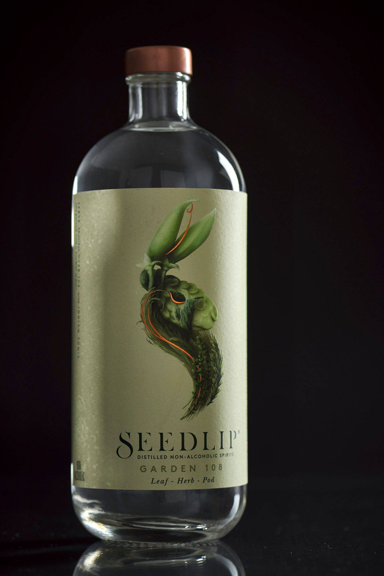 a bottle of alcohol-free spirit seedlip garden on black background