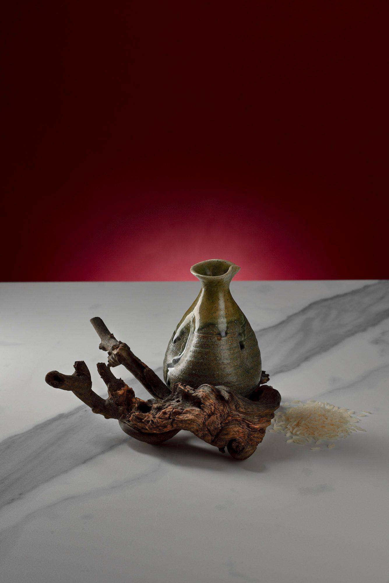 sake and rice on marbled sapienstone top with red background
