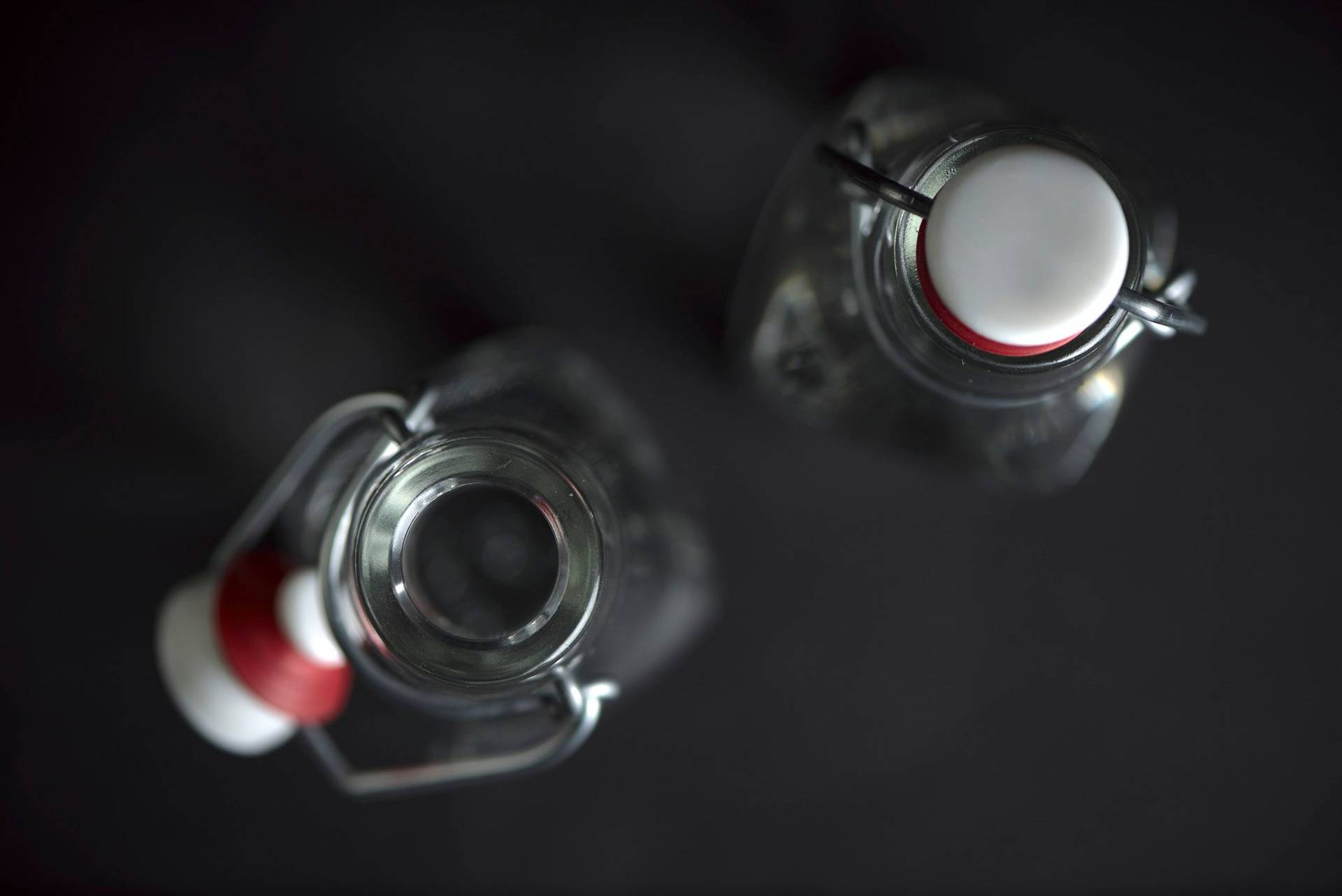 two bottles of spirits on black background