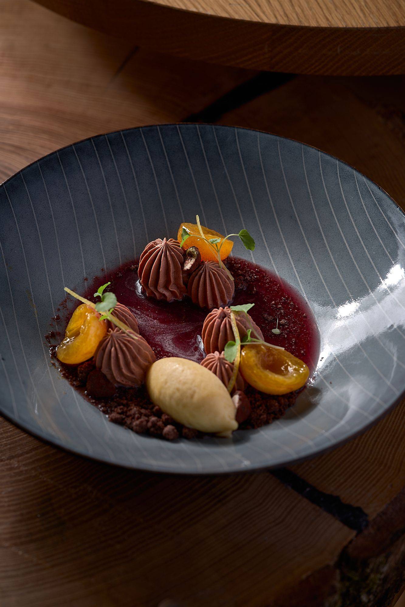 chocolate dessert with yellow plums by pastry chef nico klink