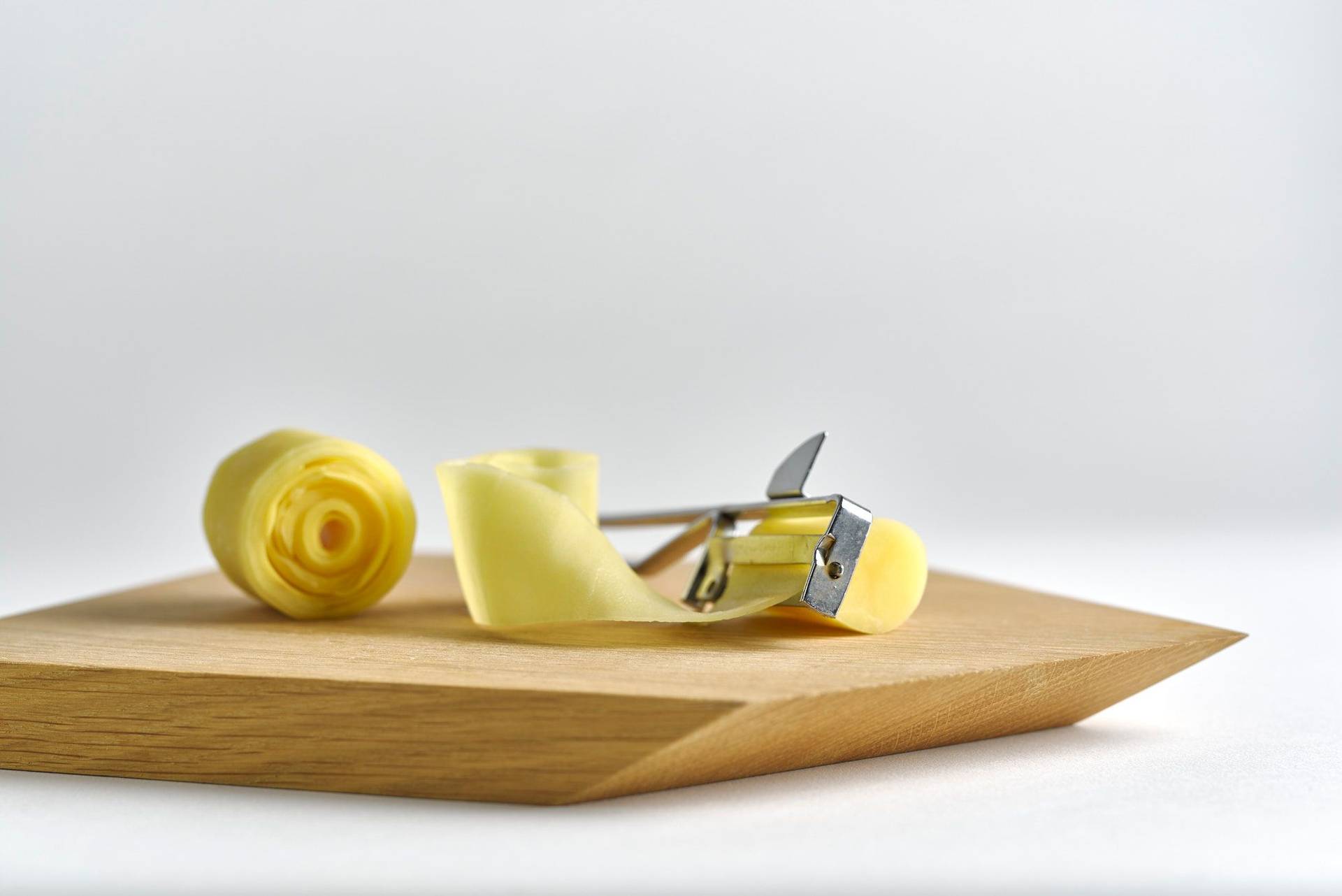 a potato swirl on a wooden board with white background