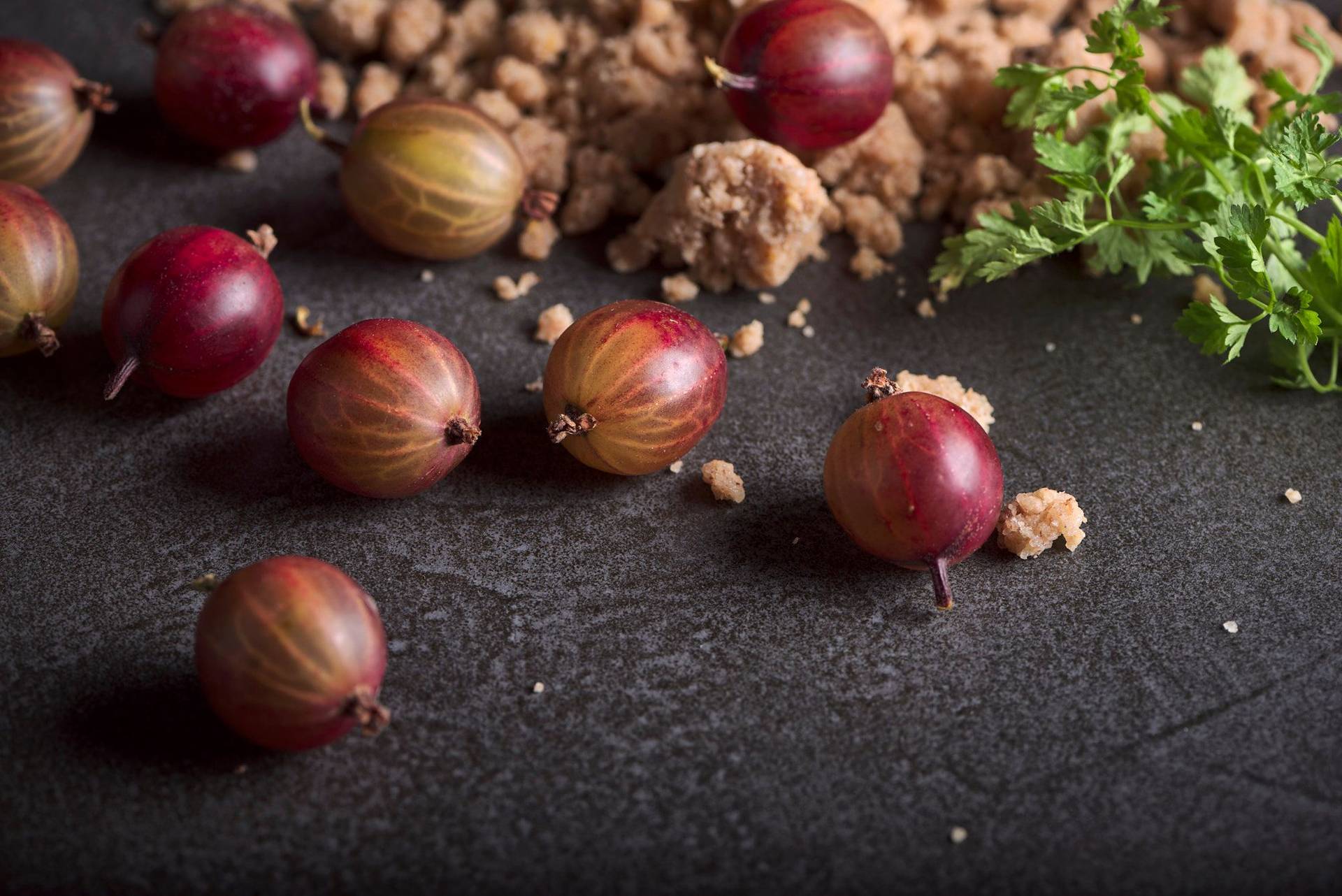 red gooseberries with spelt crumble and chervil with gray sapienstone top