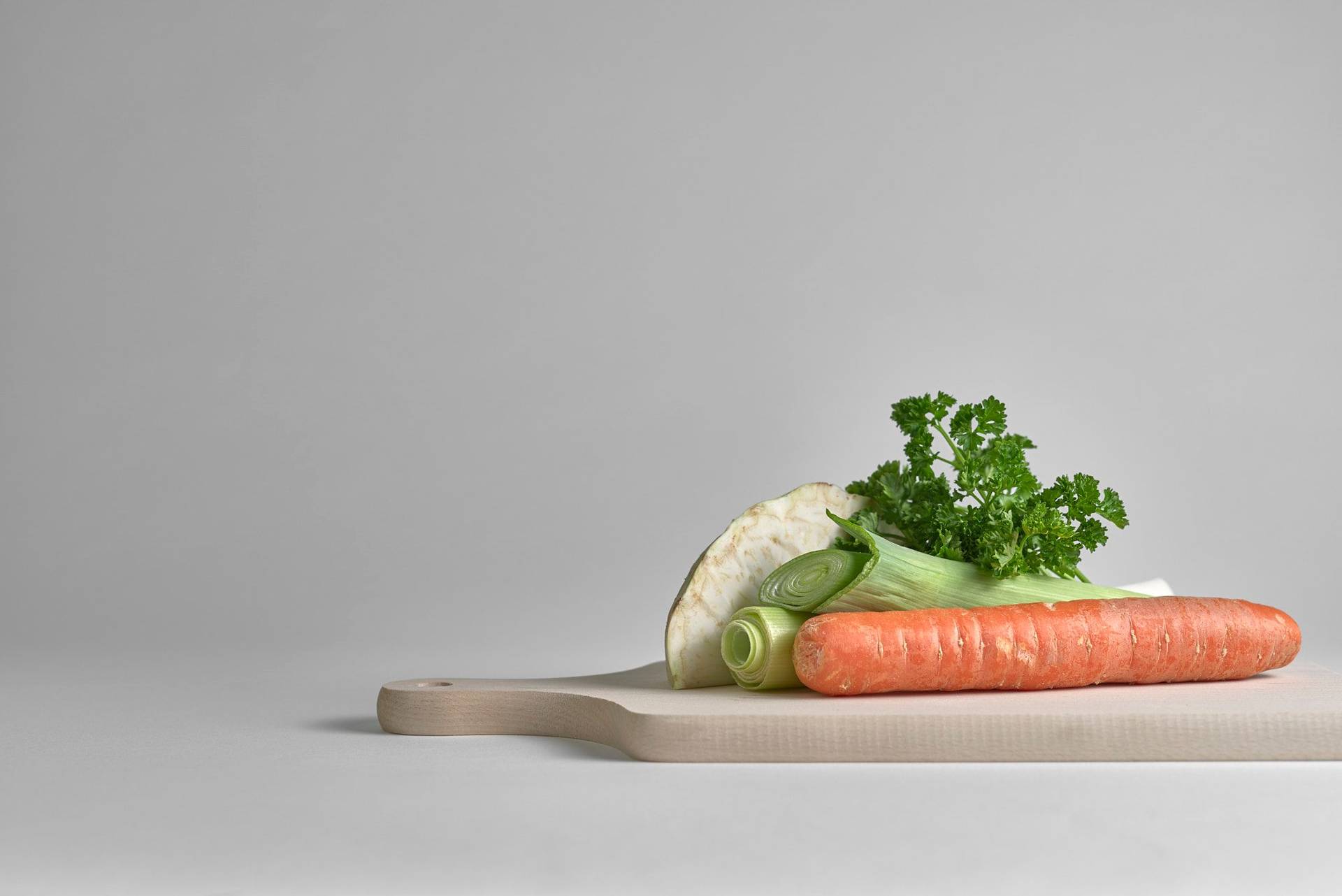 greens on a wooden board with white background