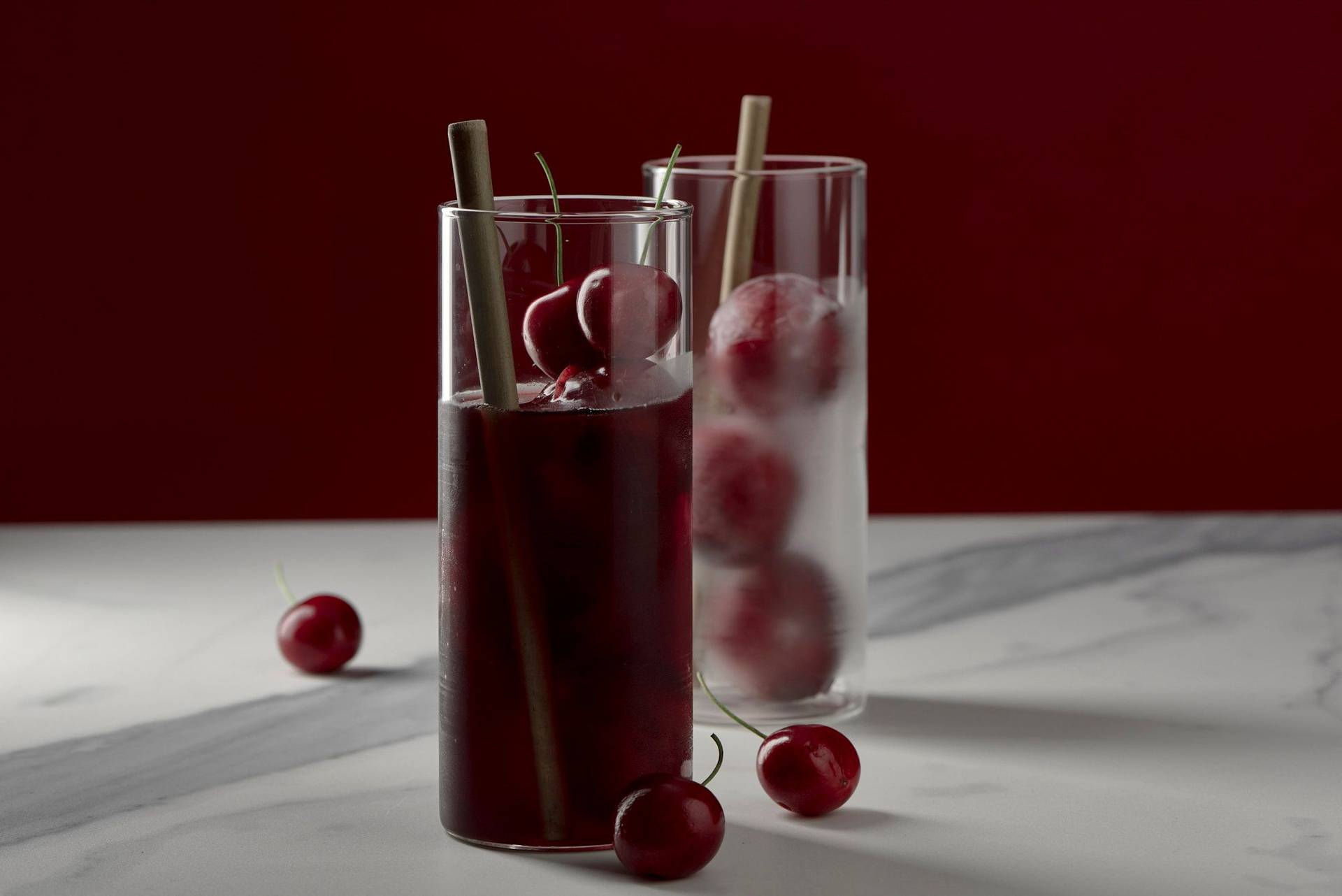 cherry-and-rice-cooler-with-sake cherry and rice cooler with sake on marbled sapienstone top with red background