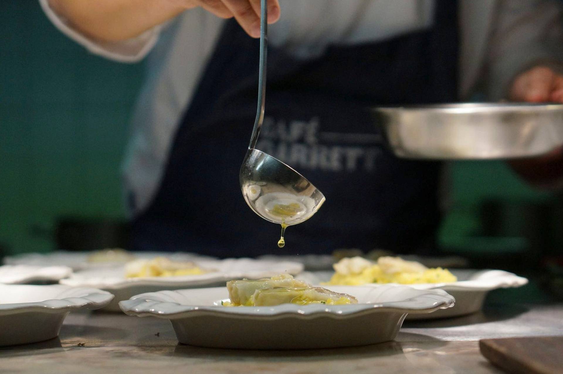 chef leopoldo calhau serving an olive oil dinner in lisbon