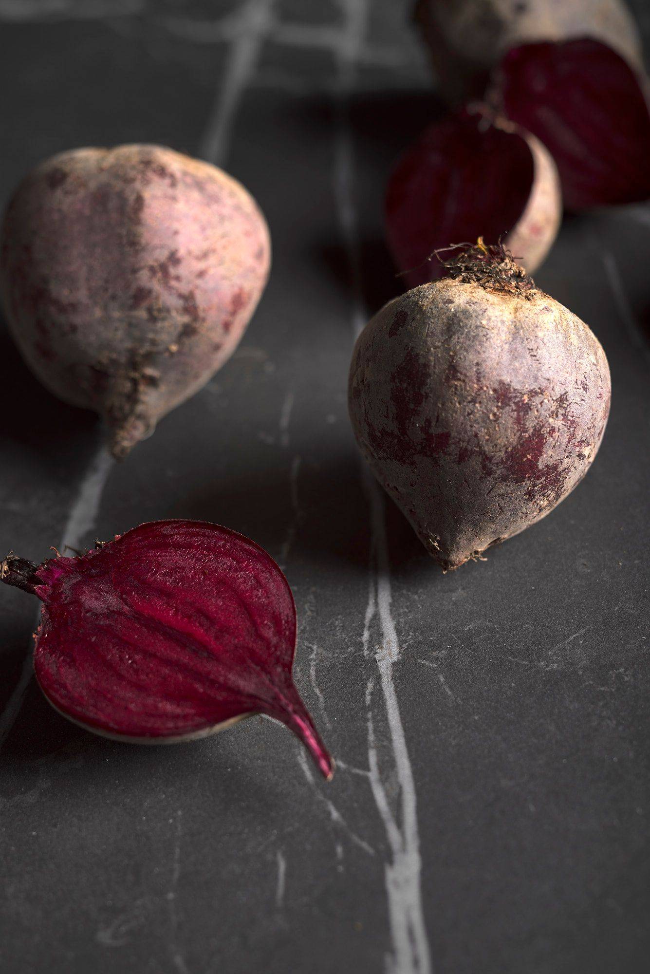 three pieces of beetroot on a gray sapienstone top