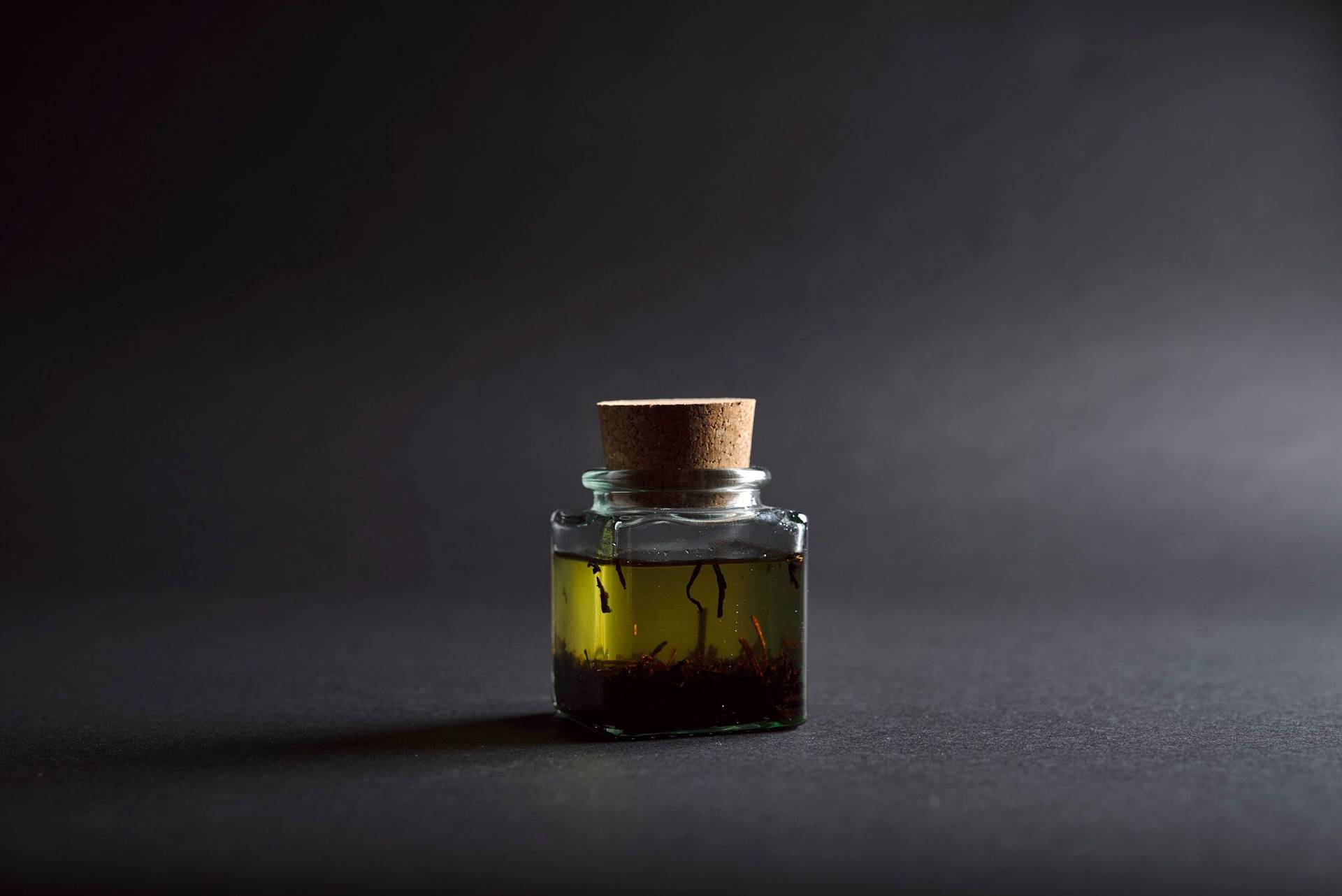 tea oil in a glass with black background