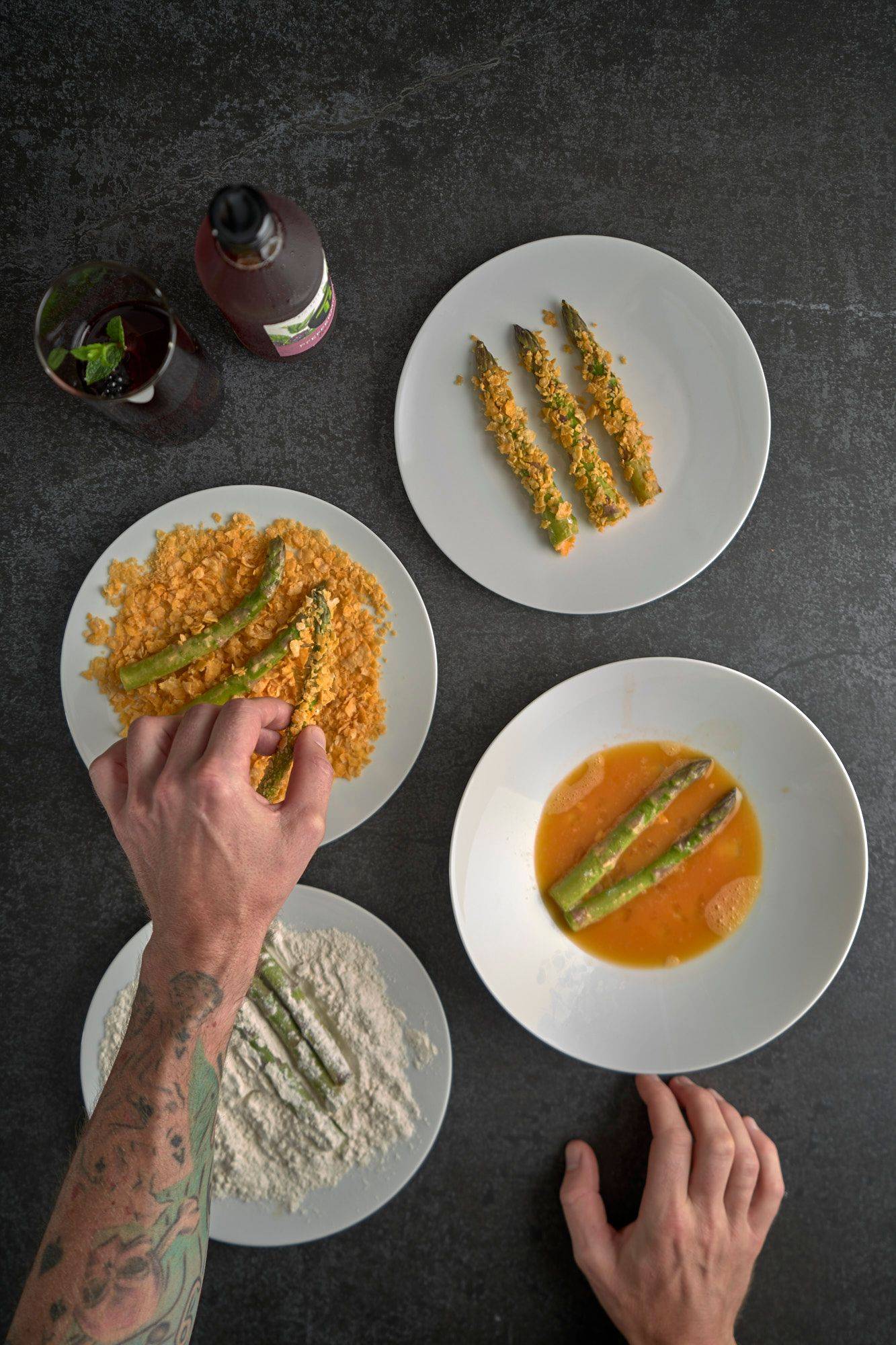 making asparagus katsu on a gray sapienstone top