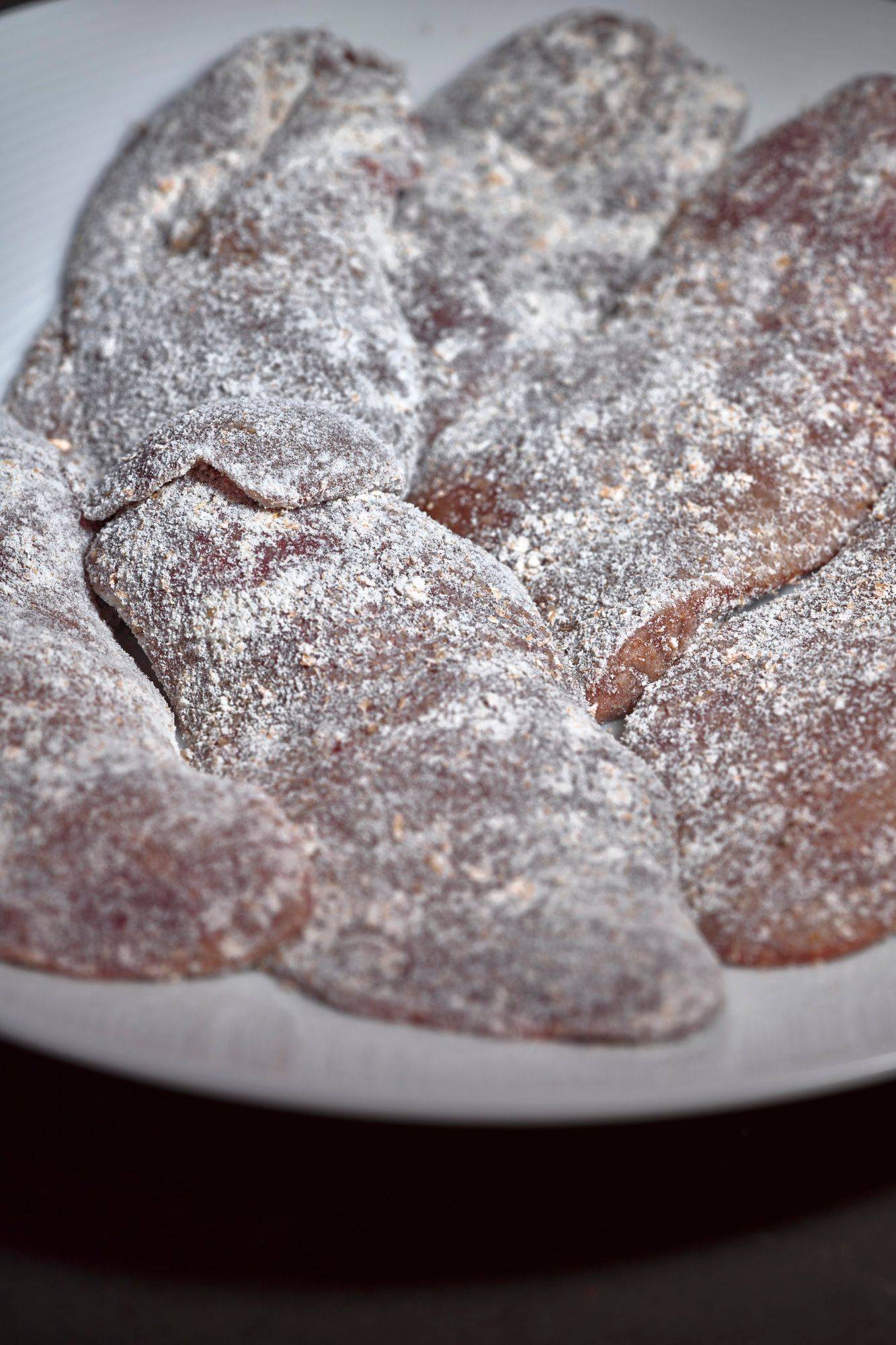 flour tossed raw chicken liver on a gray marbled sapienstone top 