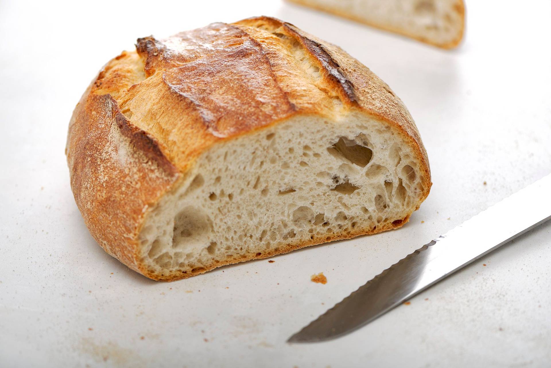 a loaf of white sourdough bread on a white sapienstone top