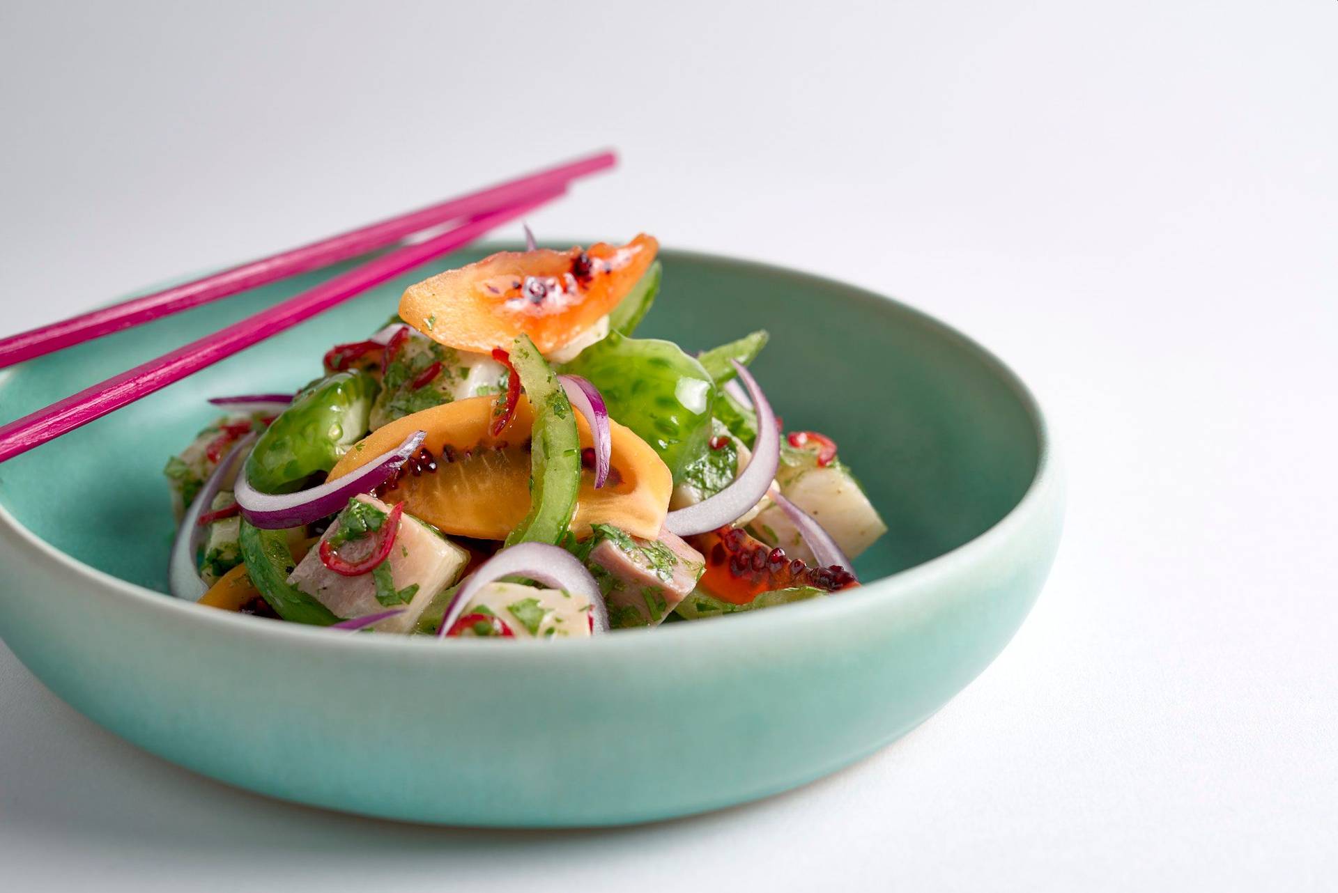 kingfish-ceviche-with-tomatoes kingfish ceviche with tomatoes in a turquoise ceramic bowl on white background