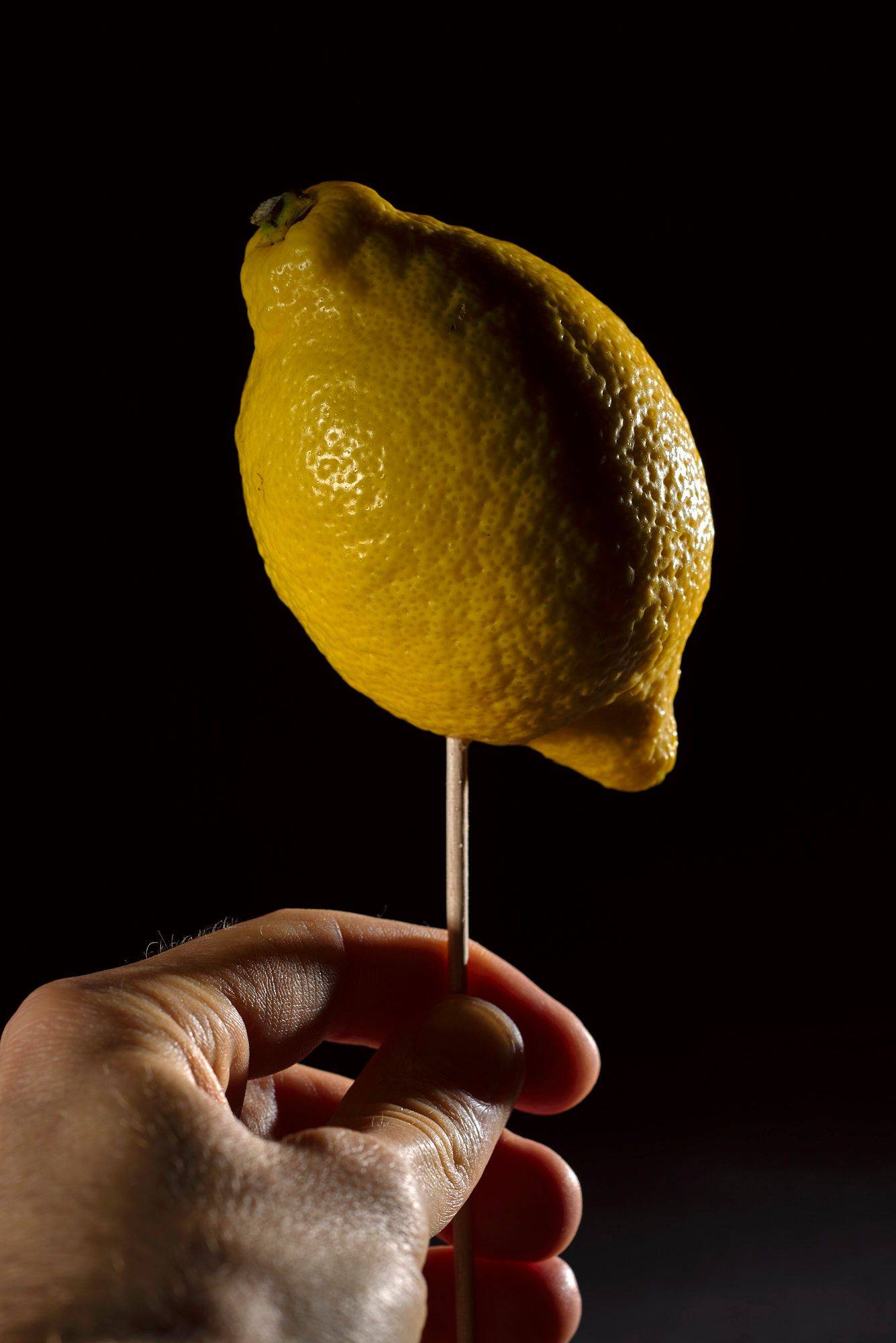 lemon pinched lemon on black background