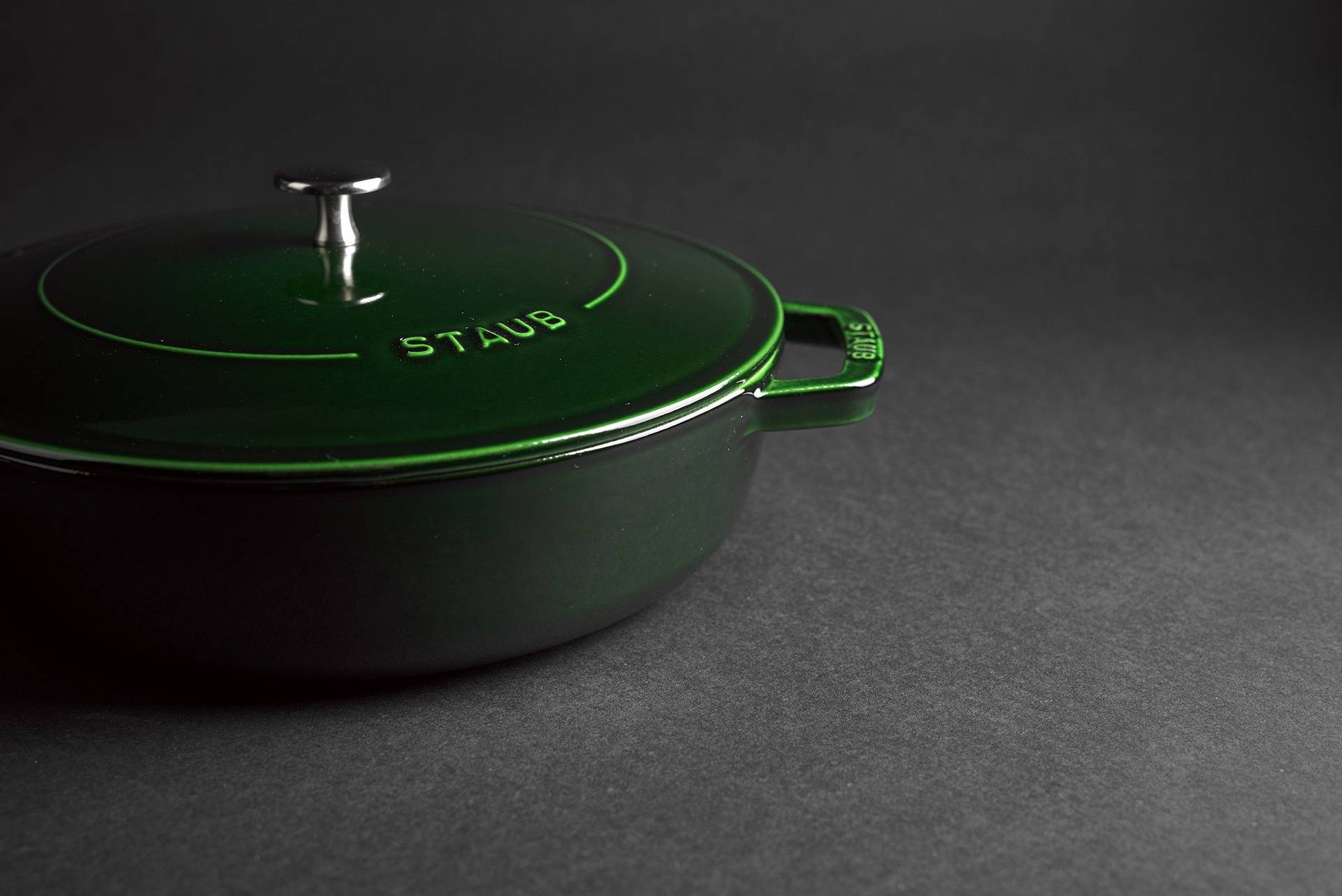 green staub la cocotte cast iron pot on black background