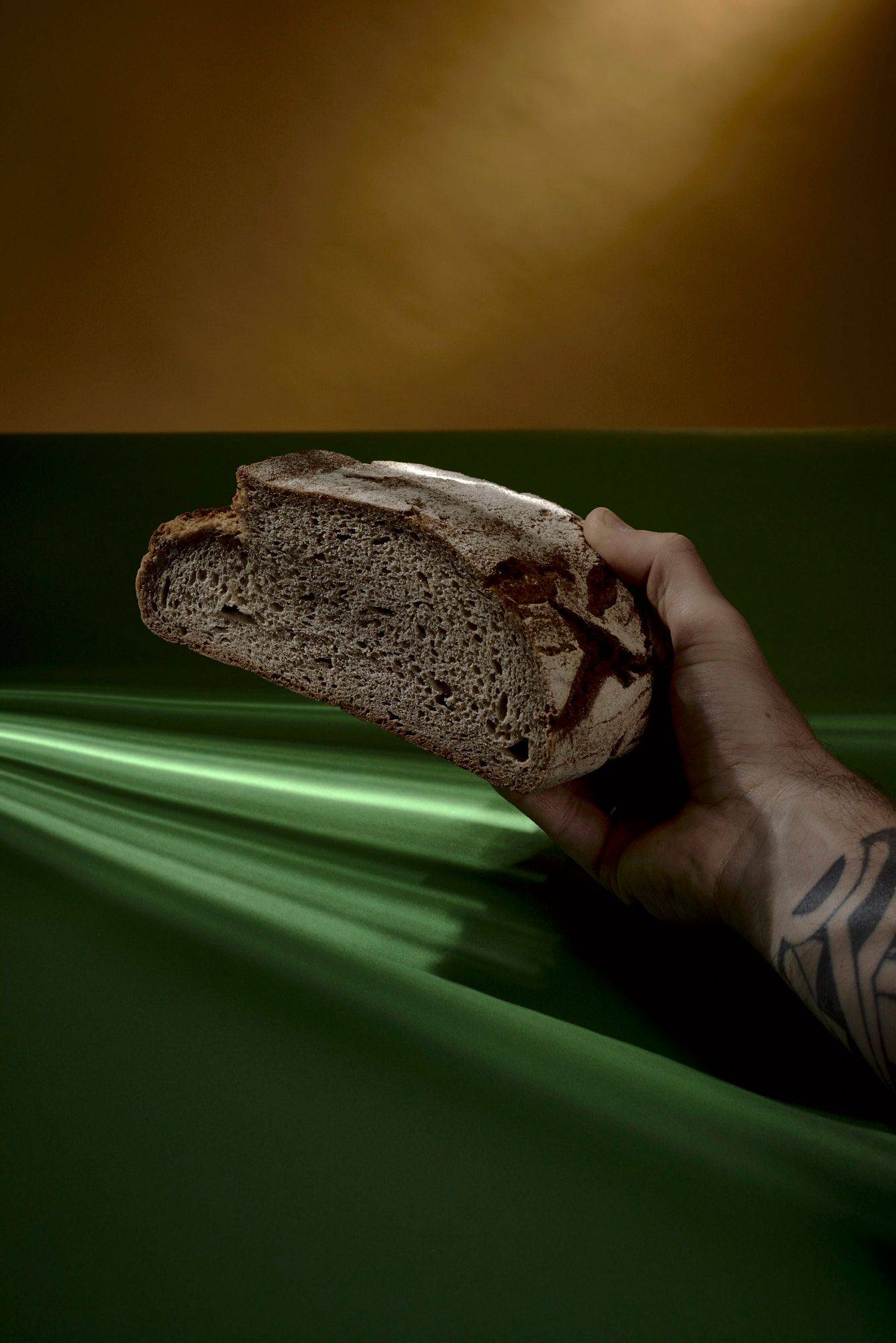 a loaf of sourdough bread with green yellow background