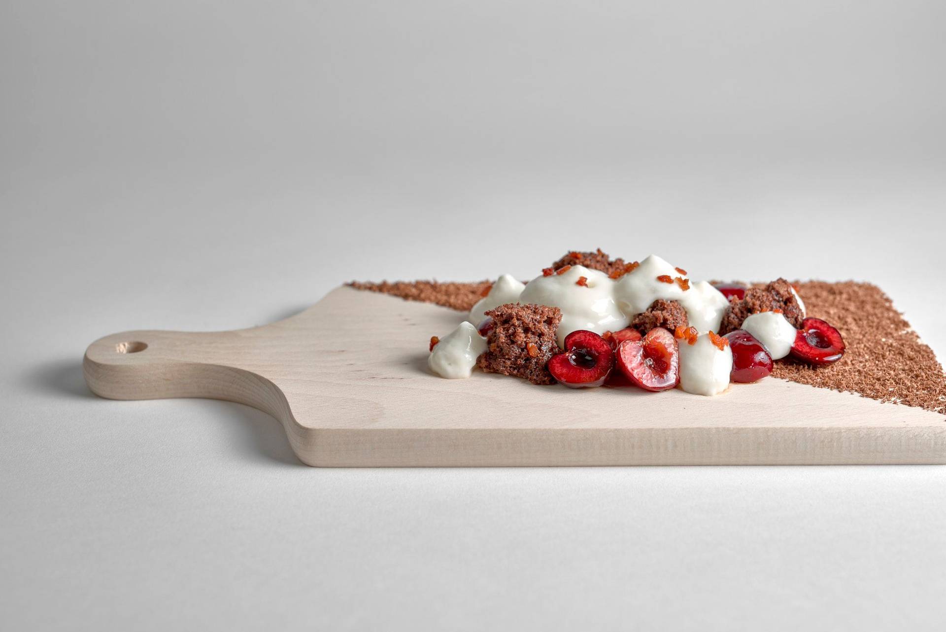 ayran black forest cake dessert with bacon on a wooden board with white background