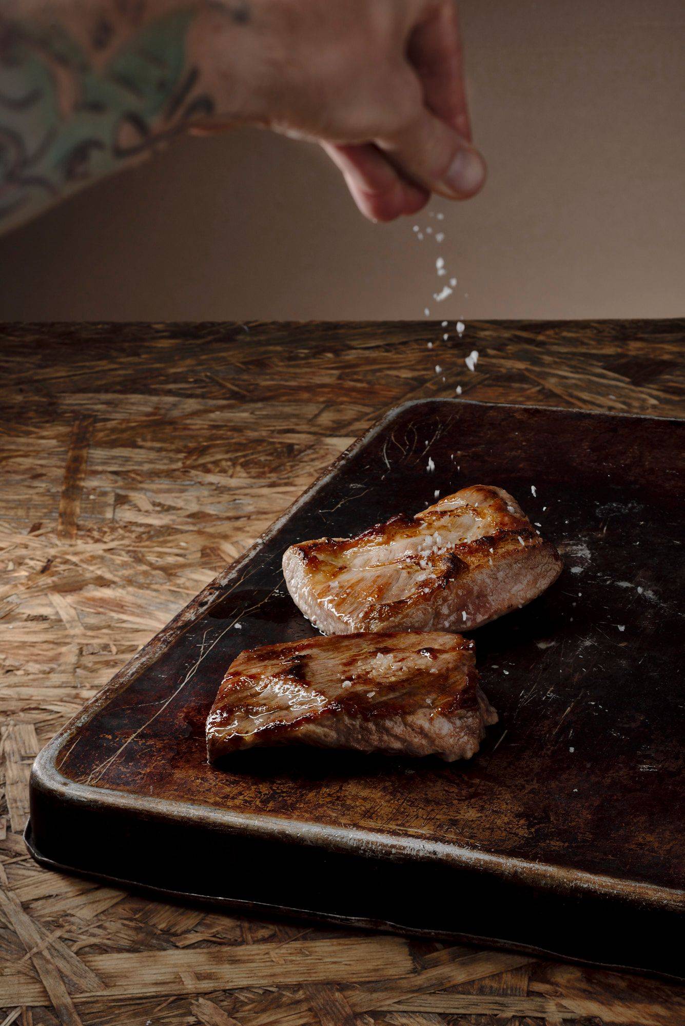 seasoning grilled pork secreto with brown wooden background