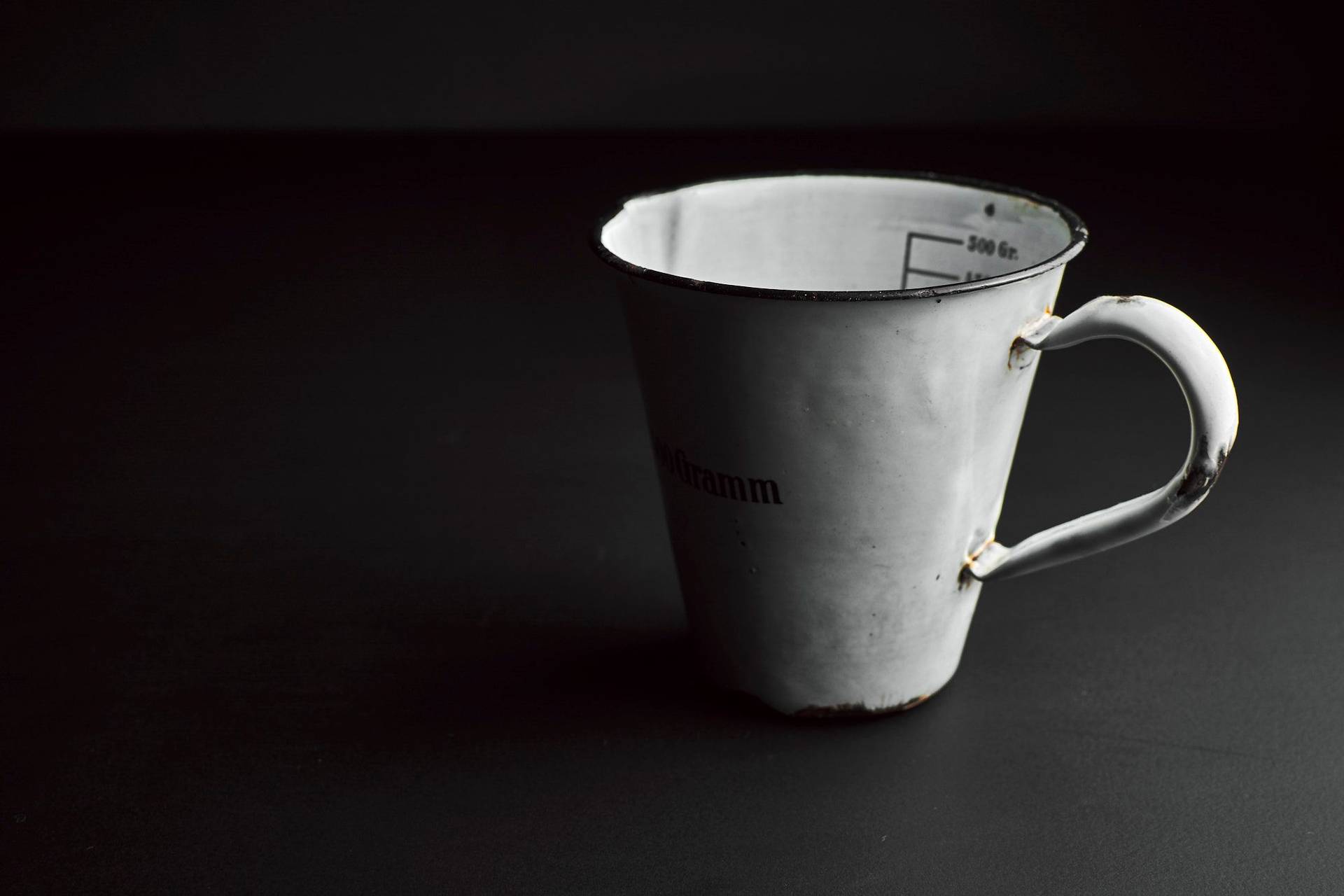 condensed milk in a vintage jug with black background