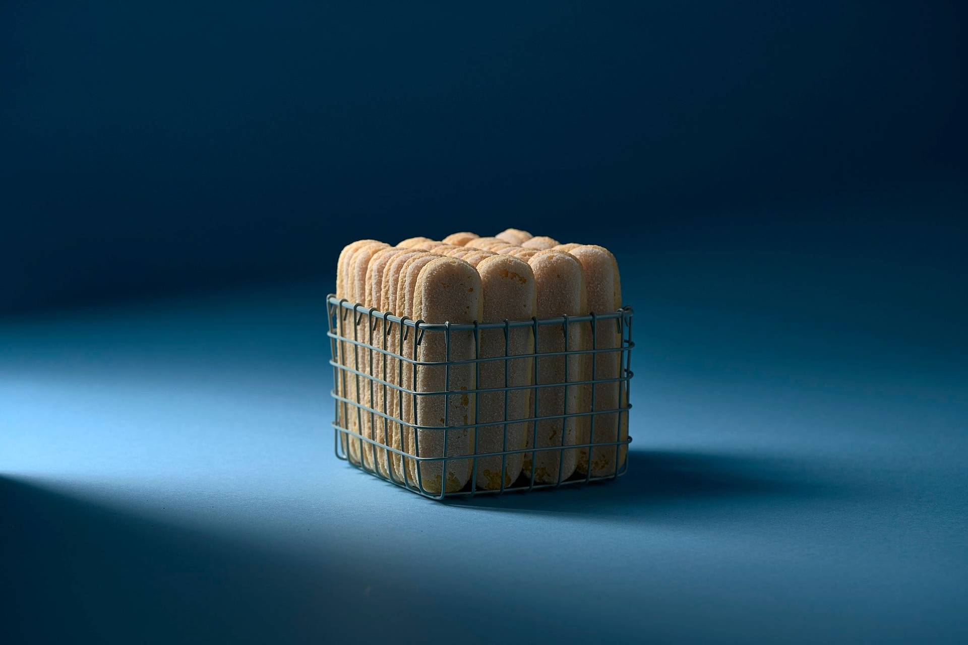 ladyfingers in a small basket with blue background