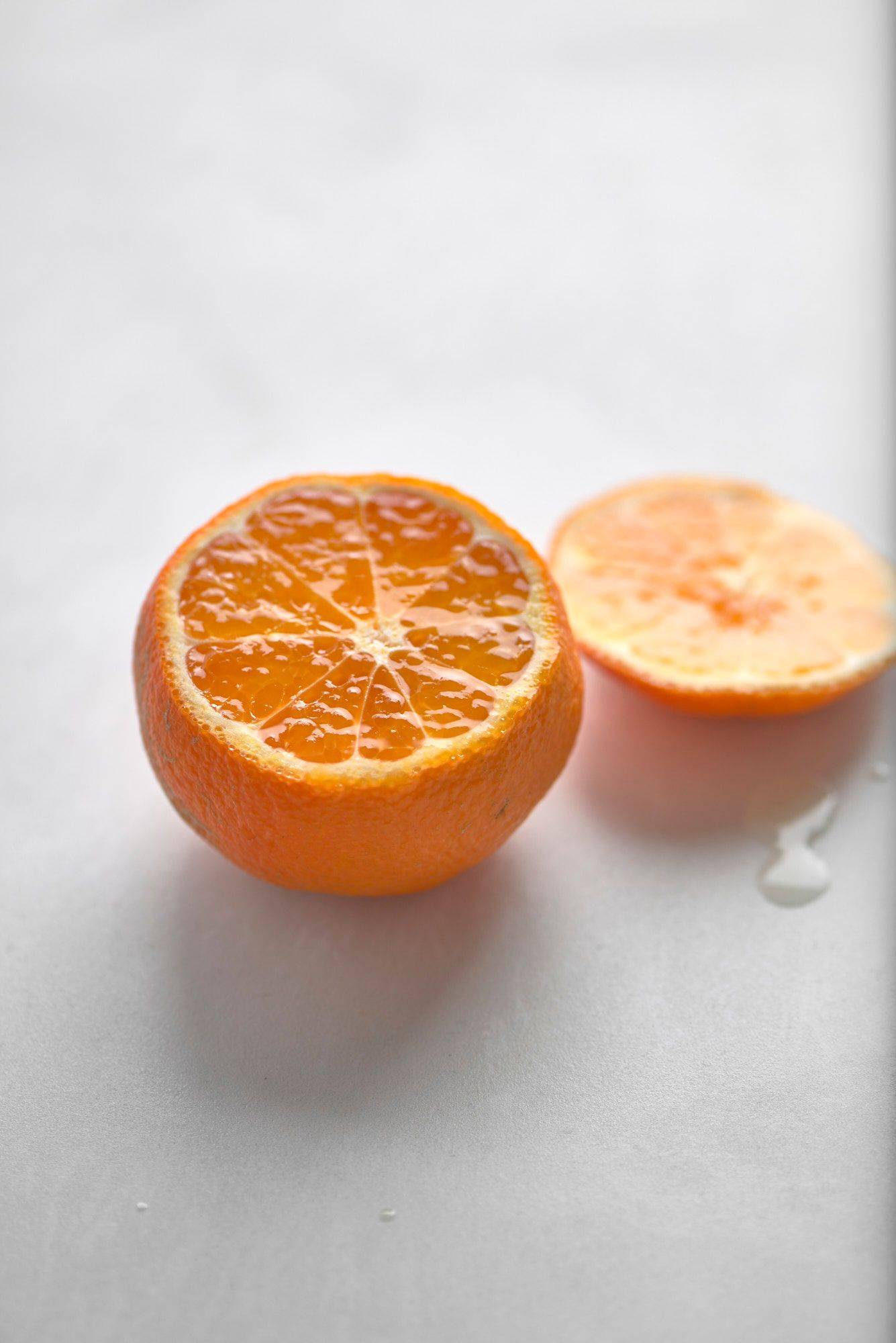 a tangerine on a white sapienstone top