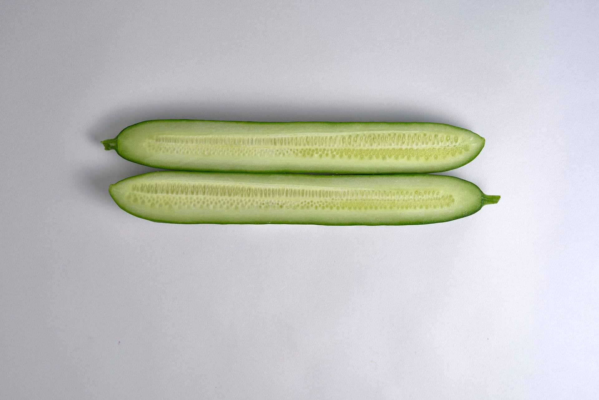 a halved cucumber with white background