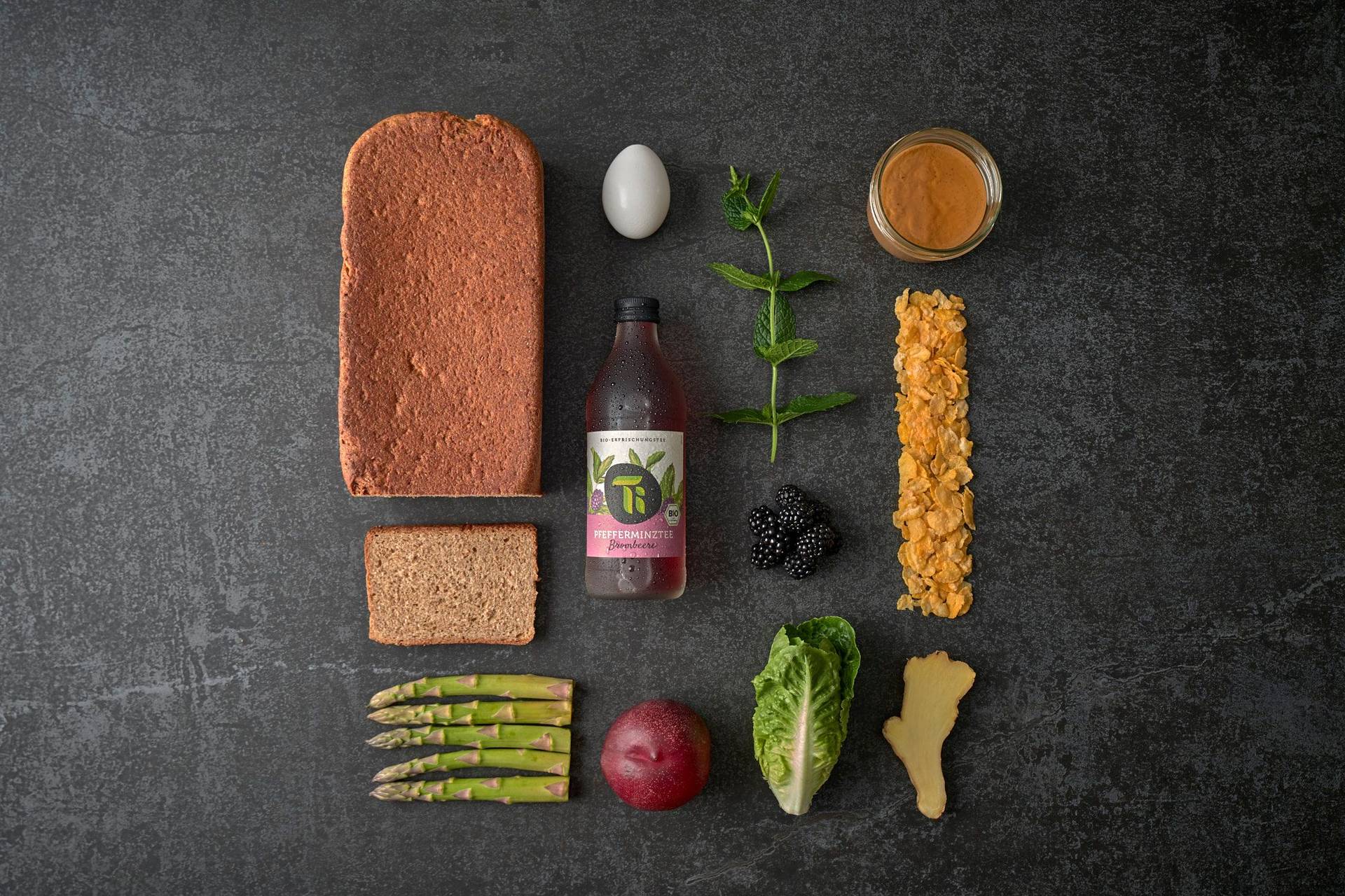 ingredients-for-vegetarian-asparagus-katsu-sando-with-nectarine-and-mint-mayonnaise ingredients for vegetarian asparagus katsu sando with nectarine and mint mayonnaise with ti refreshing tea on a gray sapienstone top