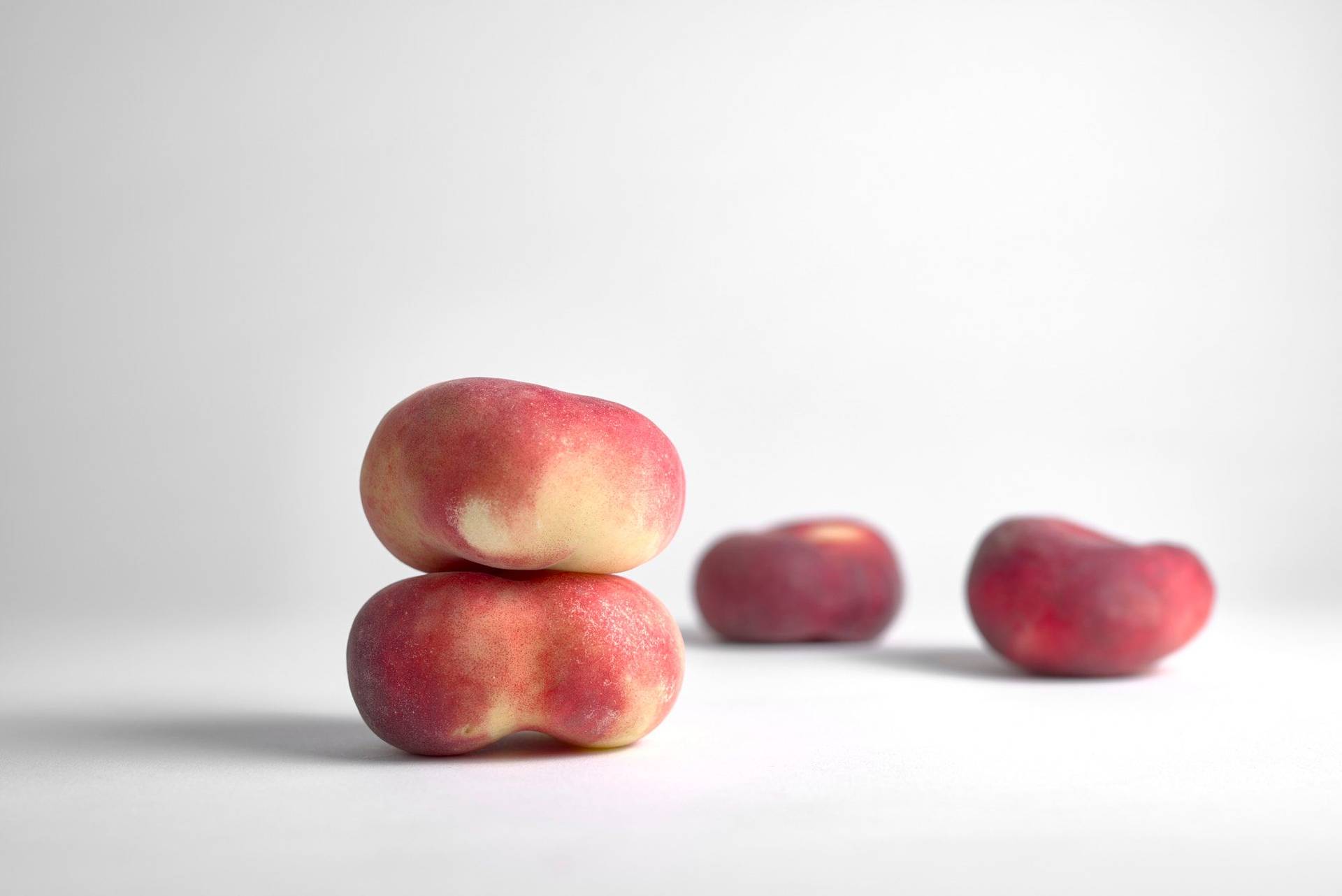 four peaches on white background