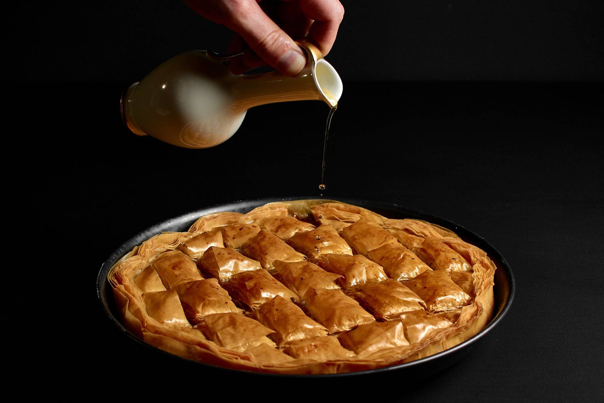 baklava-with-hazelnuts-and-walnuts baklava with hazelnuts and walnuts in a baking pan with black background