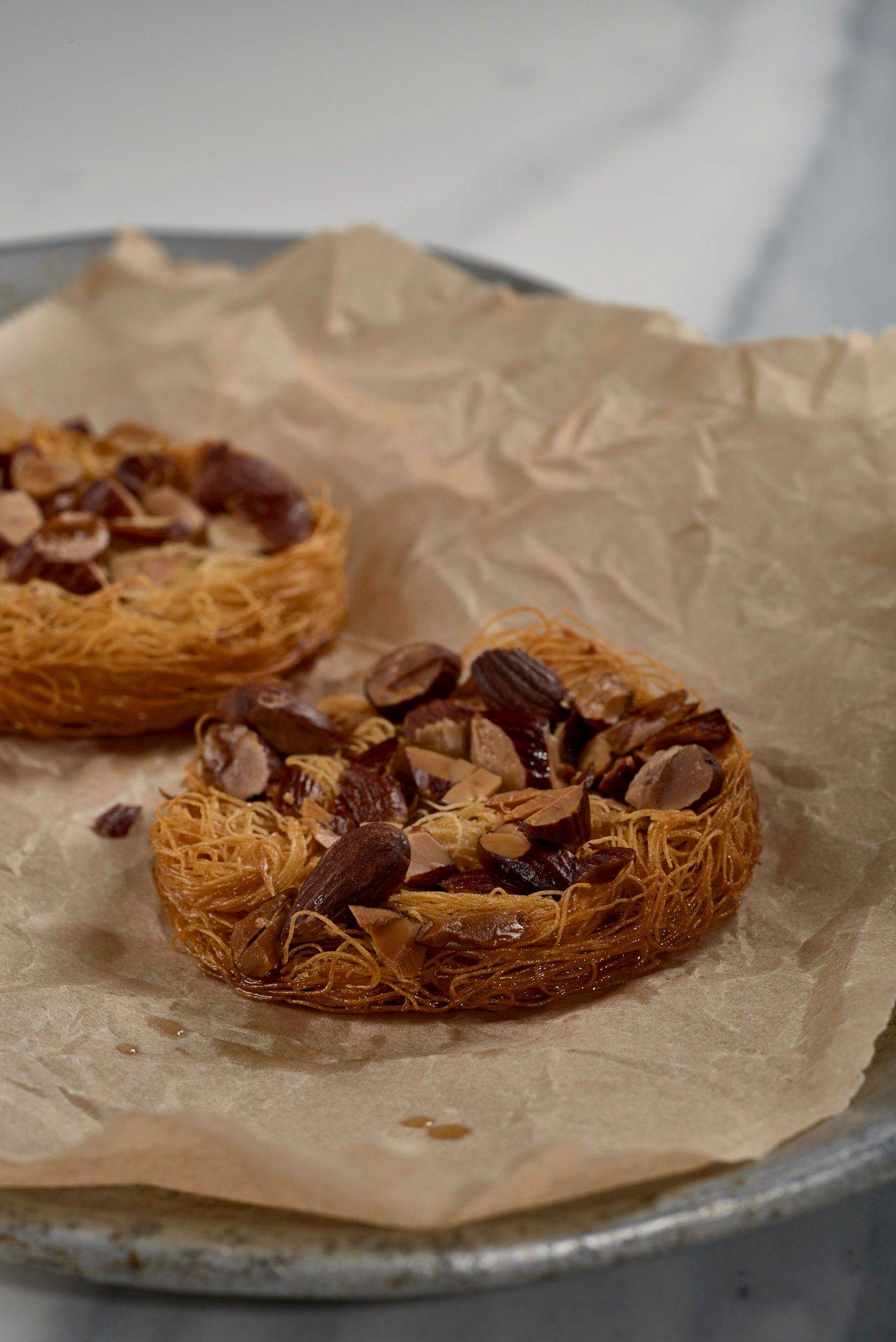 kataifi and almond cracker on a baking sheet with a marbled sapienstone top