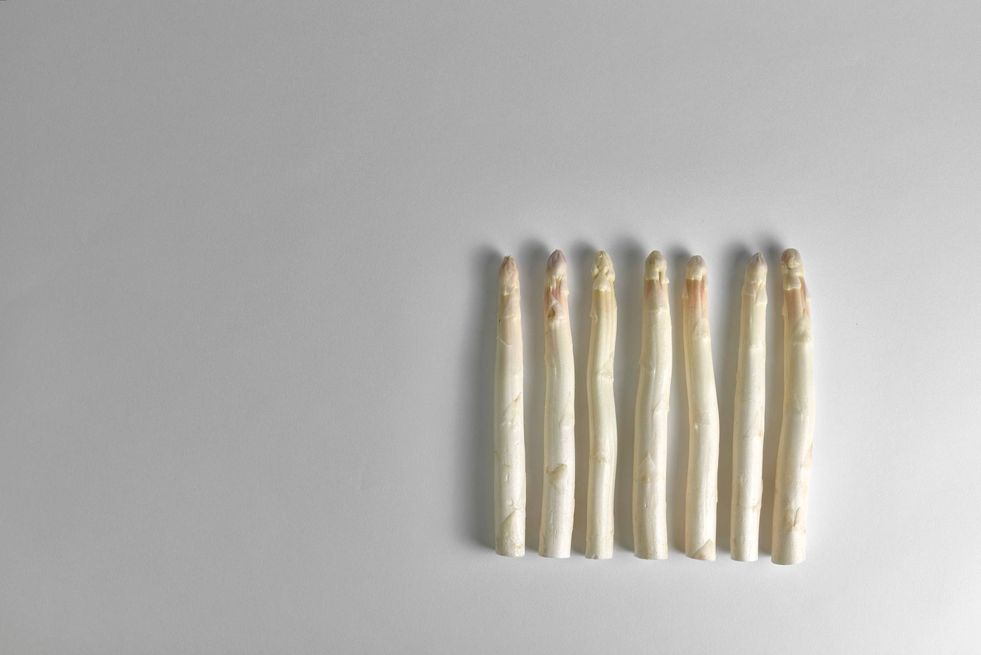 seven pieces of white asparagus with white background