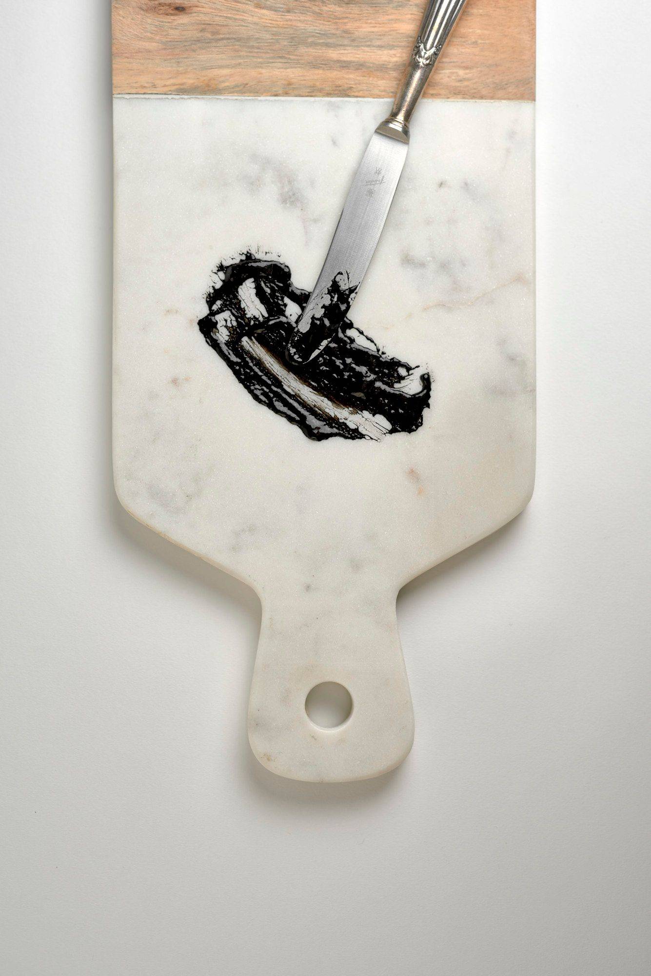 sepia-ink spread sepia ink on a marble board on white background