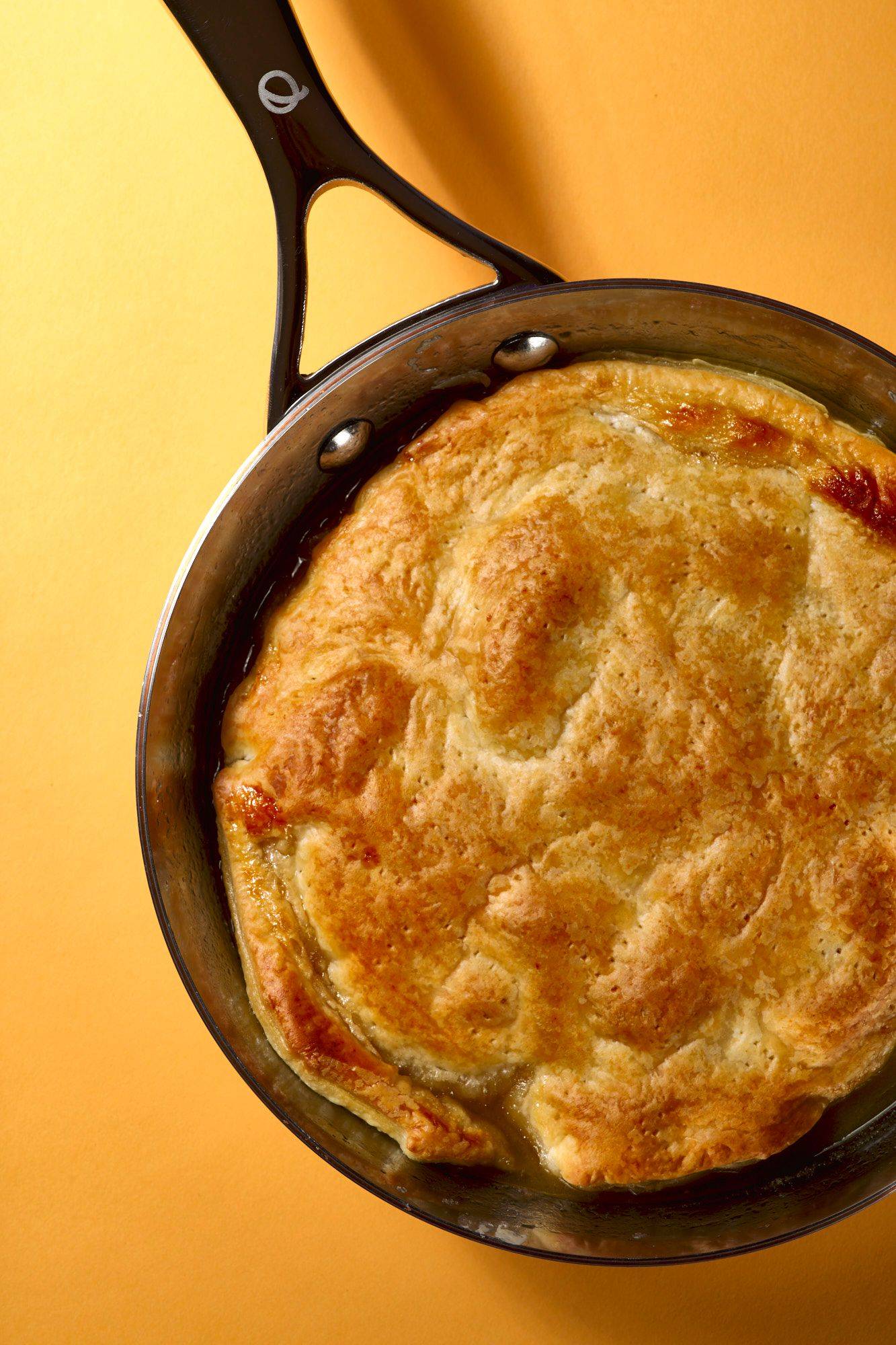 apple and ginger tarte tatin in a silver olav pan with yellow background