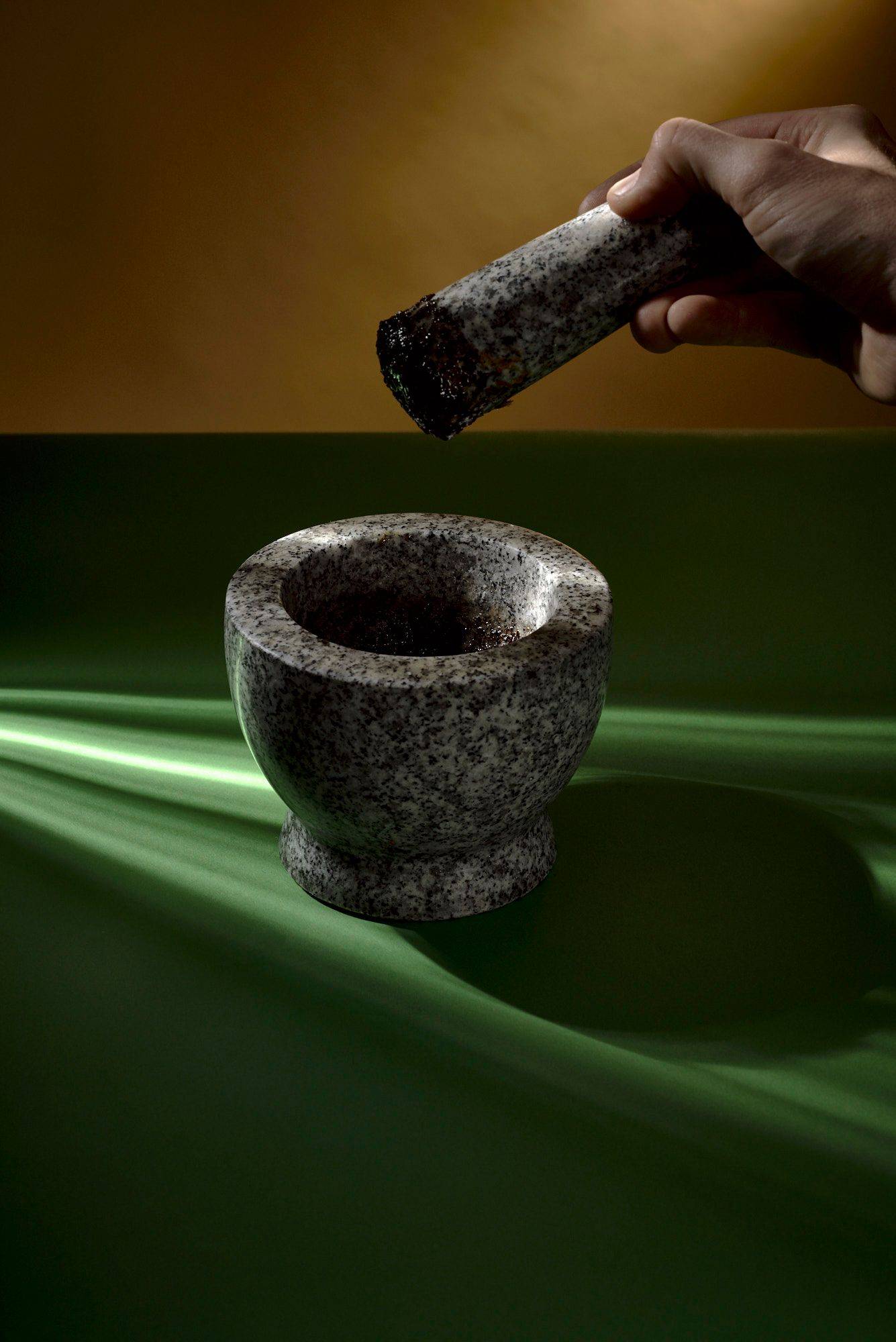 coffee-pesto coffee pesto in a mortar with green yellow background