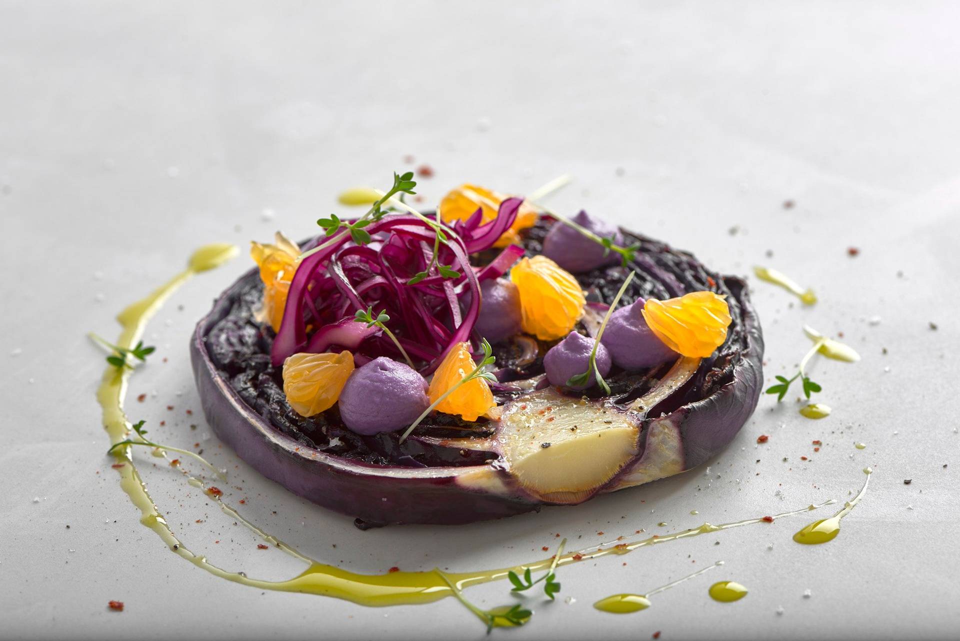 vegan red cabbage steak with cashew cream and tangerines on a white sapienstone top