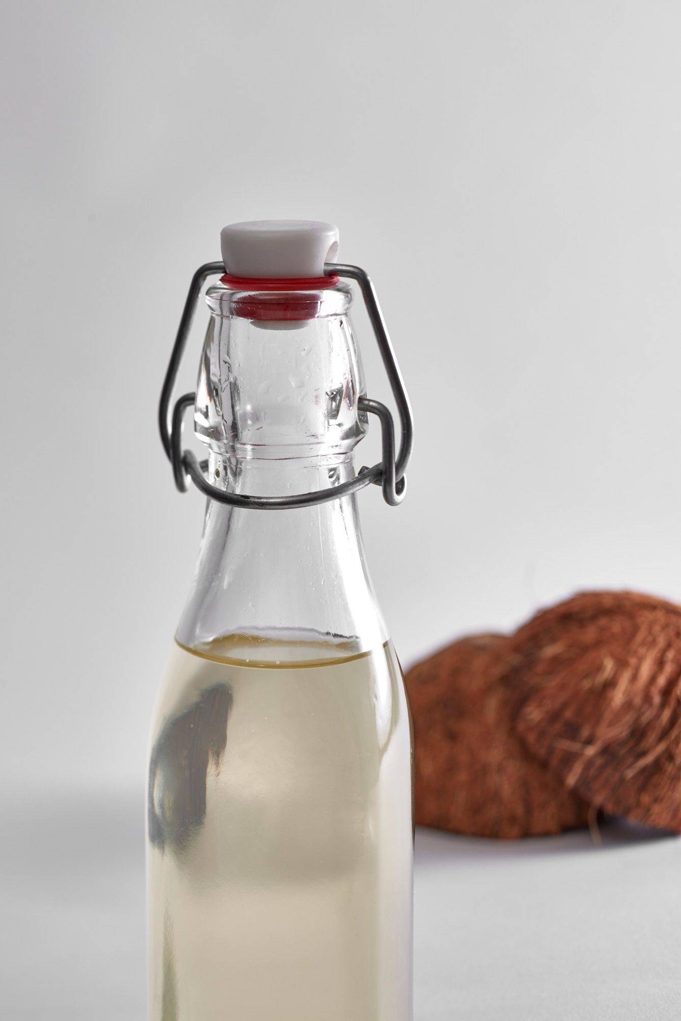 coconut syrup in a glass bottle on white background