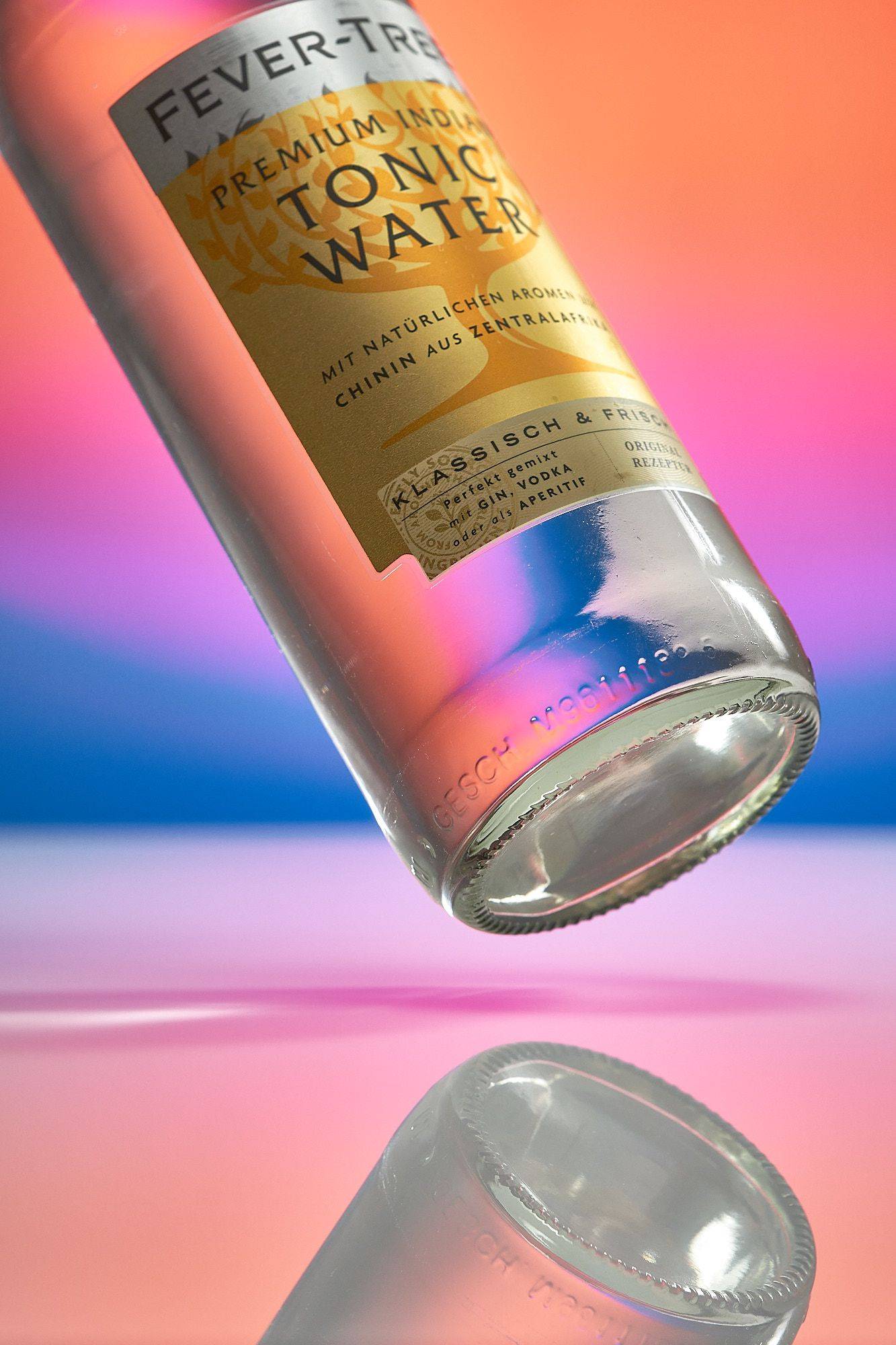 a bottle of fever tree tonic water on rainbow colored background