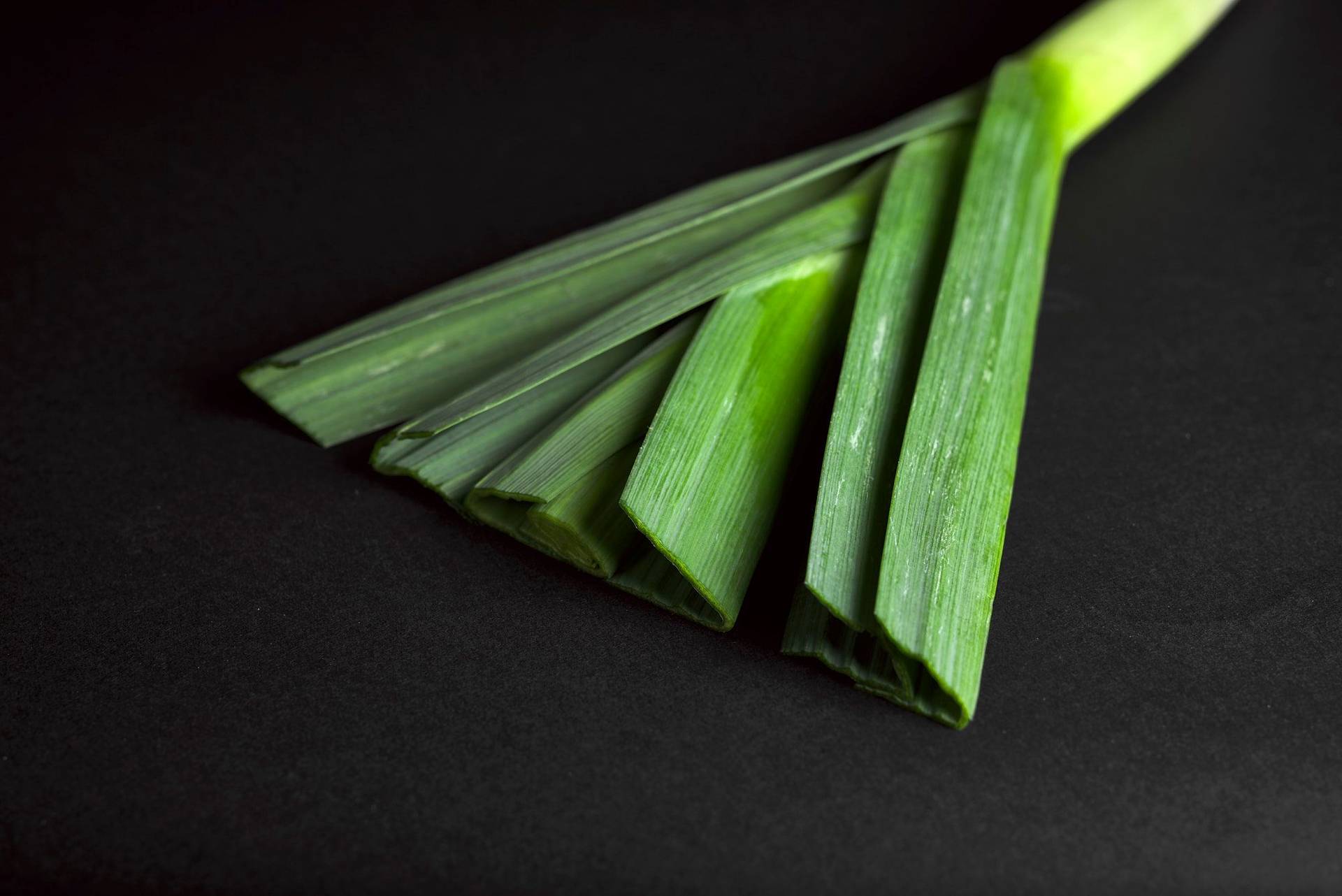a piece of leek with black background